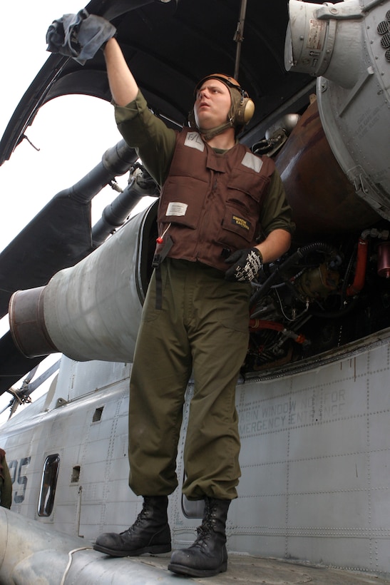 Staff Sgt. Leo Obernuefemann, Marine Medium Helicopter Squadron 365 (Reinforced) CH-53E Super Stallion flightline chief performs daily maintenance on an aircraft April 3, 2006.  HMM-365 (Rein.) is the Aviation Combat Element of the 24th Marine Expeditionary Unit and is participating in an Expeditionary Strike Group Exercise as part of its pre-deployment work-ups.