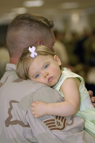 Staff Sgt. Ryan Hall holds his daughter on Monday, April 3, 2006, after returning to Charleston Air Force Base, S.C., from a six-month deployment to Camp Bucca, Iraq. Sergeant Hall is with the 437th Security Forces Squadron. (U.S. Air Force photo/Airman 1st Class Nicholas Pilch) 