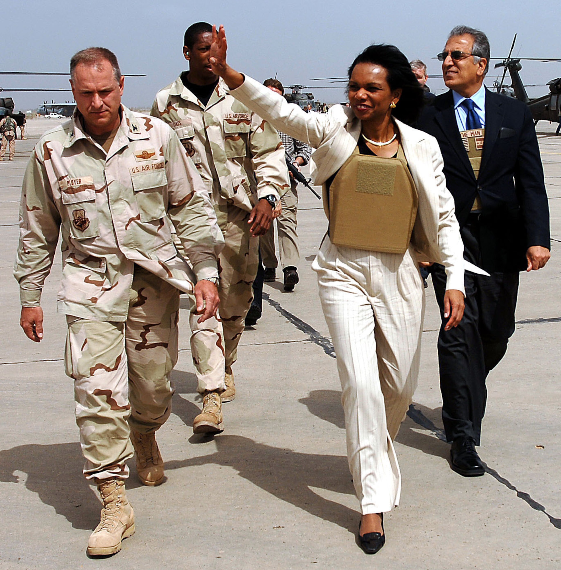 U.S. Secretary of State Condoleezza Rice waves to Airmen at Sather Air Base, Iraq, on Monday, April 3, 2006 after she and Jack Straw, United Kingdom foreign secretary, met with Iraqi officials in Baghdad. She is accompanied by Col. Dennis Ployer, 447th Expeditionary Group commander, and Zalmay Khalilzad, U.S. ambassador to Iraq. (U.S. Air Force photo/Master Sgt. Will Ackerman)
 
