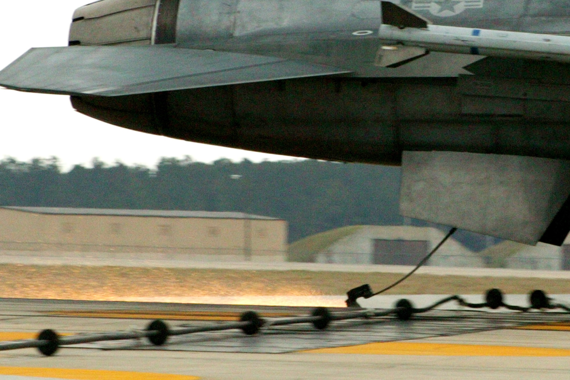 The hook from an F-16 Fighting Falcon slides in to grab the arresting system's cable. (U.S. Air Force photo/Senior Airman John Gordinier)

