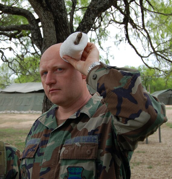 Tech. Sgt. John Jackson, from the Air Force Reserve Command's 433rd Civil Engineering Squadron sticks to training in a self aid and buddy care class during a recent bivouac. 433rd CES Airmen maintain proficiency in life saving skills through regular practice. (U.S. Air Force photo by Senior Airman Jonathan Simmons) 