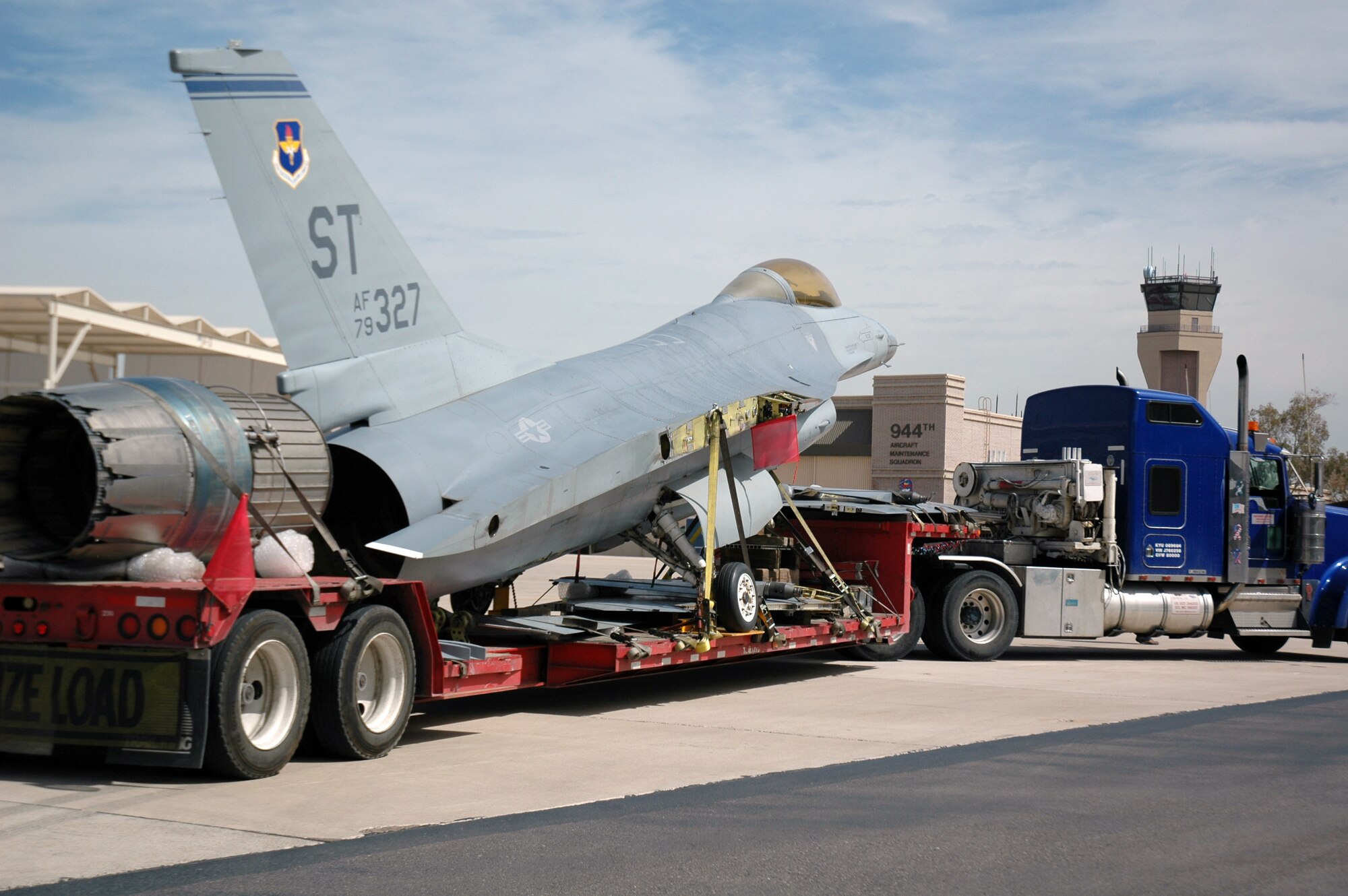 The contractor, Worldwide Aircraft Recovery Services, prepares to unload an F-16, tail number 79-0327, at Luke Air Force Base April 4. The F-16, which came from Sheppard Air Force Base, Texas, will become a static display in front of the 944th Fighter Wing headquarters painted in World War II Tuskegee colors complete with a red tail. The F-16 is scheduled to be unveiled as part of the annual Tuskegee Convention, which will be in Phoenix in August. (U.S. Air Force Reserve photo by Staff Sgt. Susan Stout)
