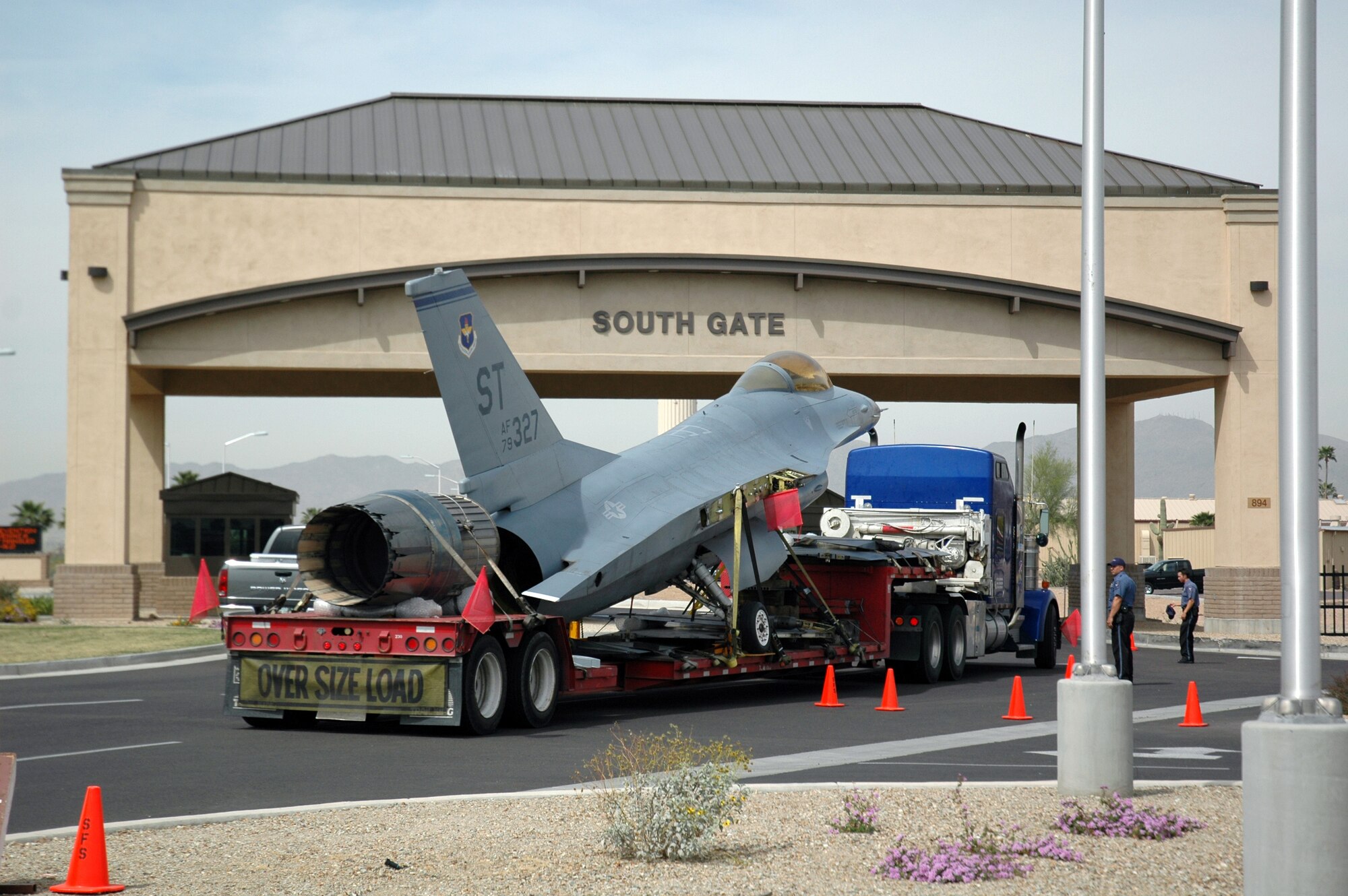 An F-16, tail number 79-0327, arrives at Luke Air Force Base's south gate on April 4. The F-16 will become a static display in front of the 944th Fighter Wing headquarters painted in World War II Tuskegee colors complete with a red tail. The F-16 is scheduled to be unveiled as part of the annual Tuskegee Convention, which will be in Phoenix in August. (U.S. Air Force Reserve photo by Staff Sgt. Susan Stout)