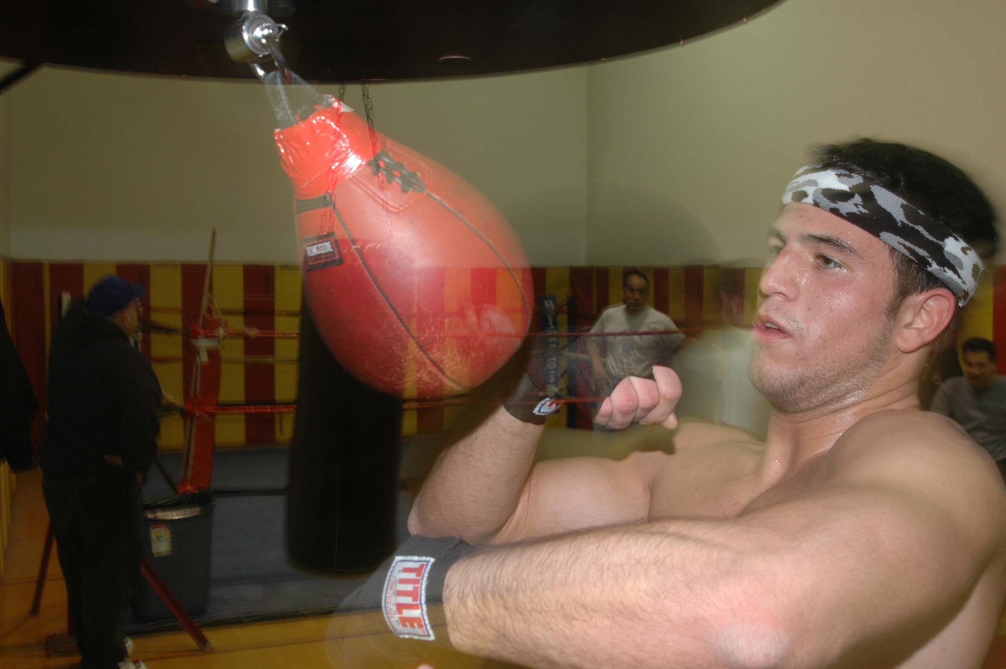 Senior Airman Nick Delaurentis, with the 434th Services Flight, hits the "speed bag" while training at the Melrose Park Civic Center training facility in the Chicago area. The boxer is training to become Chicago's Golden Glove Champion. U. S. Air Force photo by Senior Airman Roberto Modelo.