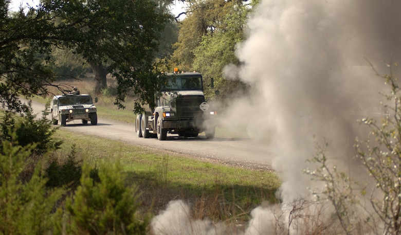 Airmen training in up-to-date convoy tactics and techniques are attacked in a simulated improvised explosive device detonation during the Basic Combat Convoy Training course at Camp Bullis, Texas, on Monday, April 3, 2006. The course is designed to keep Airmen battlefield focused and well-trained for convoy operations. (U.S. Air Force photo/Tech. Sgt. Cecilio Ricardo Jr.)  