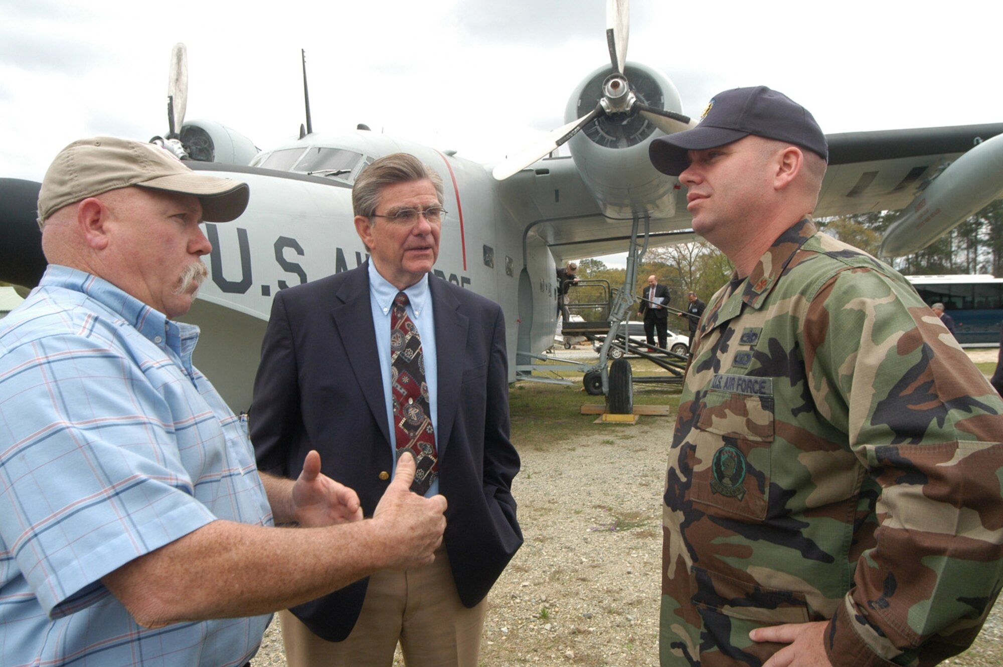 ROBINS AIR FORCE BASE, Ga. - From left,  Dennis Oliver, Museum of Aviation chief of restoration, speaks with Gene Daub, Middle Georgia Technical College Aircraft Maintanance division chairman, and Maj. Paul Kanning, 653rd CLSS commander, at the rededication ceremony of the HU-16B Albatross, pictured in the background. (Air Force photo by Sue Sapp)

