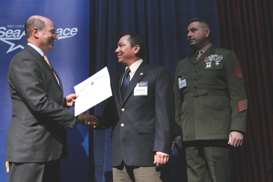 Secretary of the Navy Donald C. Winter presents the Safety Awards at the Sea-Air-Space Exposition on Tuesday, April 4, 2006 in Washington.  The moderator is Dick Macke. Photo by Lisa Nipp for SEA POWER