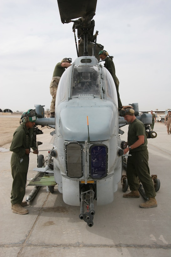 Phase maintenance Marines begin a maintenance inspection on an AH-1W Super Cobra in Al Taqaddum, Iraq, April 4. The Marines in the phase maintenance section, Marine Light Attack Helicopter Squadron 369, Marine Aircraft Group 16 (Reinforced), 3rd Marine Aircraft Wing, conduct inspections on their squadron's helicopters every 200 flight hours. They look for cracks in the airframes and change out parts such as engines and transmissions.