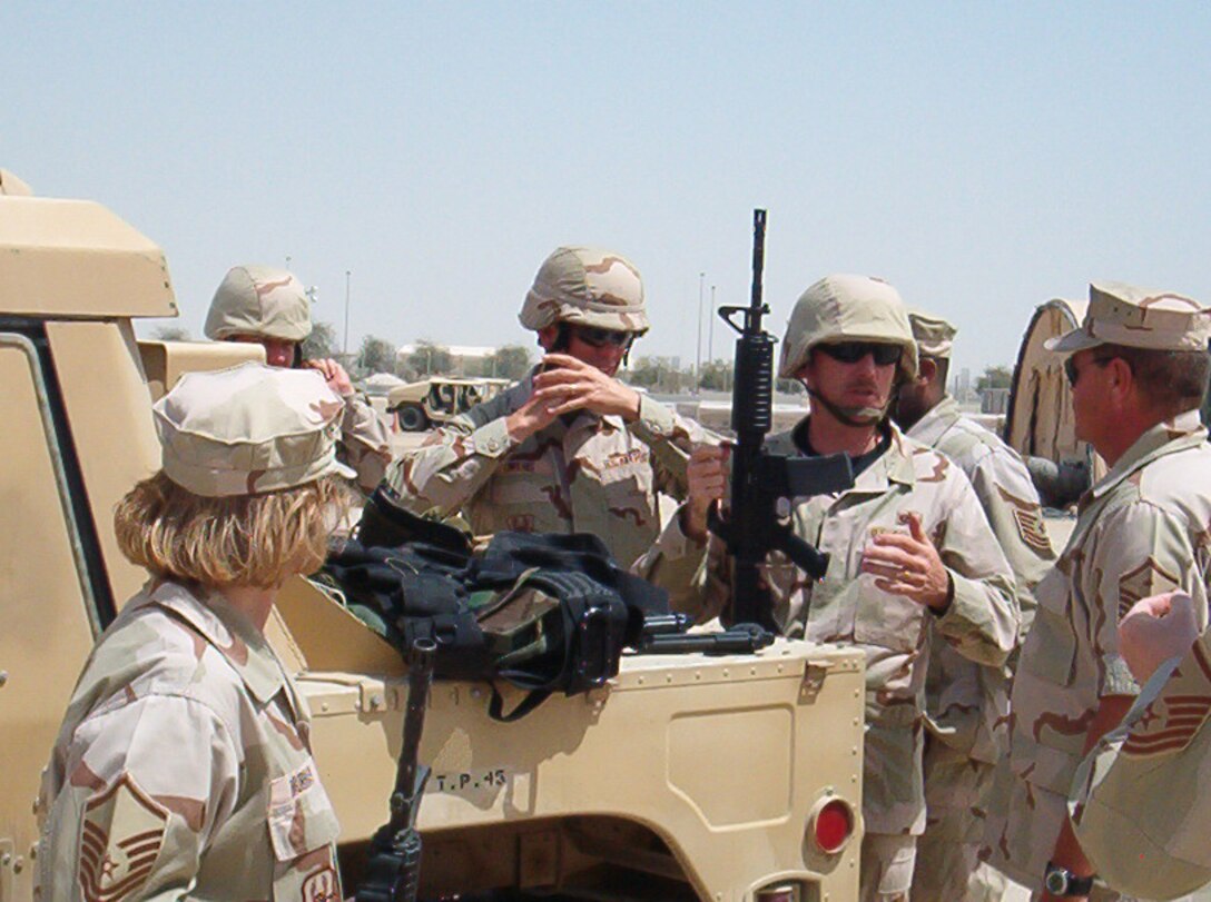 Master Sgt. David Merris (center holding the M-16) discusses operations with Master Sgt. Michael Tyndall (on his left.)  Sergeants Merris and Tyndall are Reserve first sergeants with the 944th Fighter Wing who are deployed to Al Dhafra, UAE. (U.S. Air Force photo)