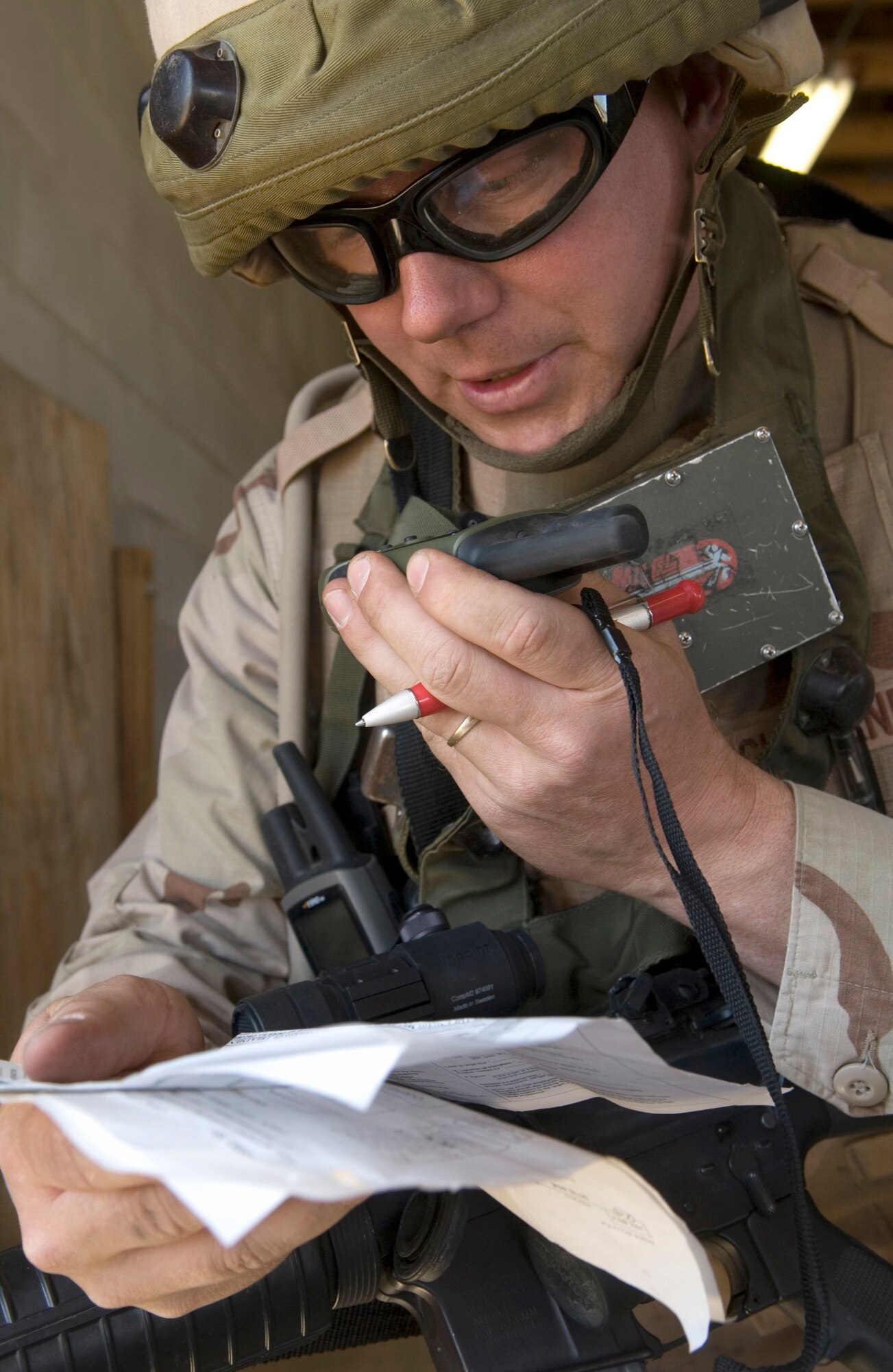 Lt. Col. (Dr.) Christopher Scharenbrock calls in a request for airlift after a simulated attack during training on Tuesday, April 4, 2006, at Fort Bragg, N.C.  Colonel Scharenbrock is an emergency medical doctor with the 60th Medical Operations Squadron at Travis Air Force Base, Calif. He is a member of the multi-service provincial reconstruction team which is helping with the reconstruction, security and governing of Afghanistan. The team is training in the United States before deploying for a year. (U.S. Air Force photo/Master Sgt. Jack Braden)

