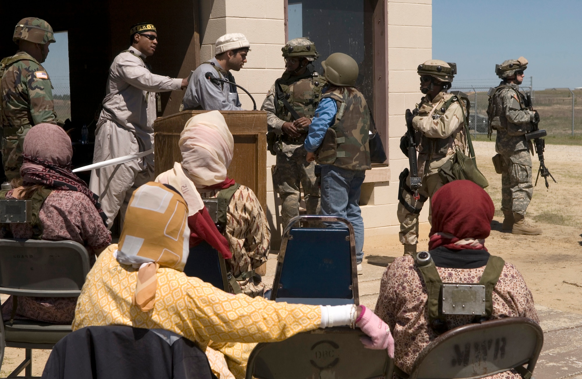 Airmen and Soldiers from a multi-service provincial reconstruction team work through a community relations scenario during training Tuesday, April 4, 2006, at Fort Bragg, N.C. The team's aim is to help with the reconstruction, security and governing of Afghanistan.  The team is training in the United States before deploying for a year. (U.S. Air Force photo/Master Sgt. Jack Braden)

