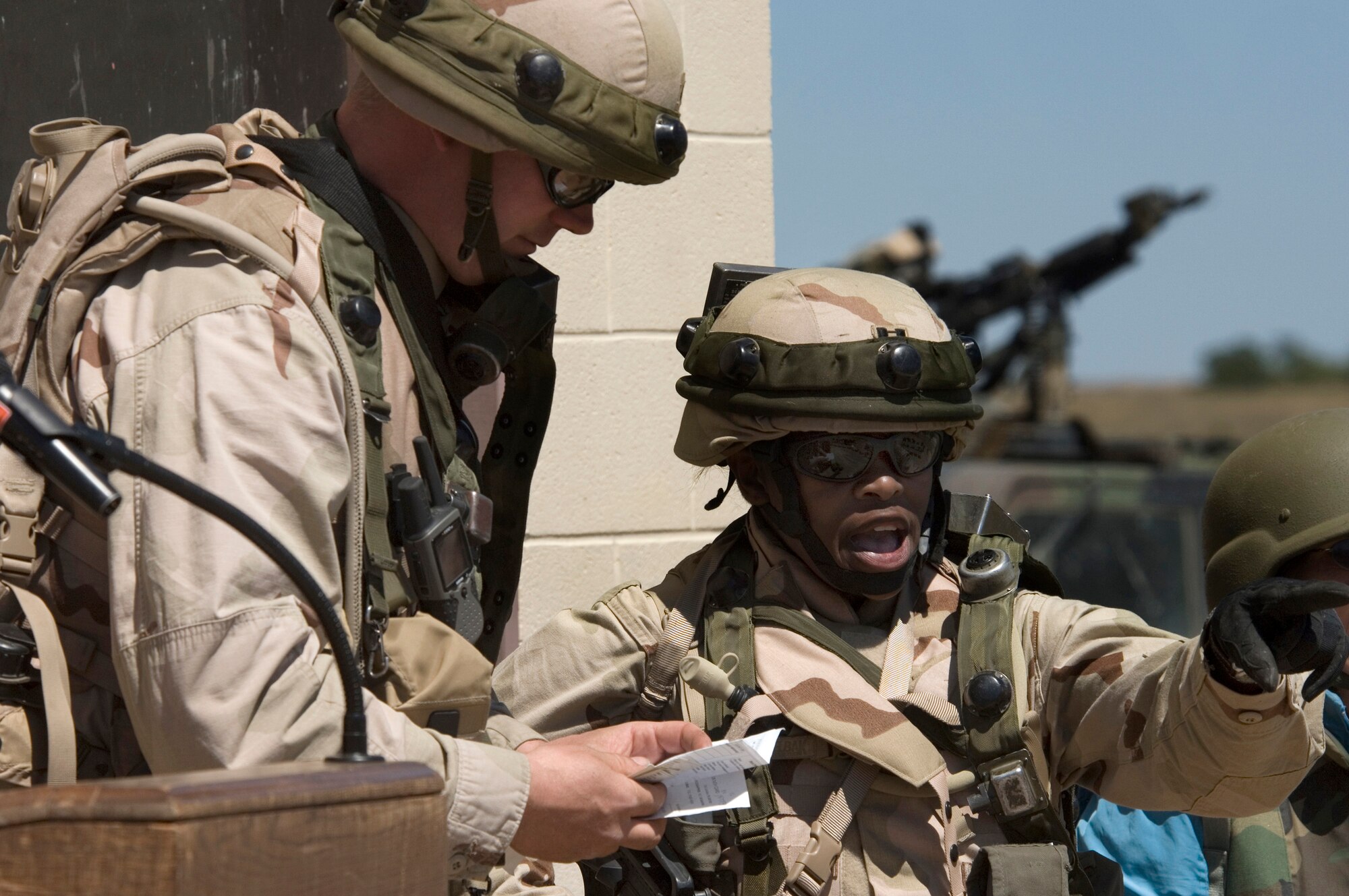 Capt. Jacqueline King, right, updates Lt. Col. (Dr.) Christopher Scharenbrock of the status of simulated victims during training on Tuesday, April 4, 2006, at Fort Bragg, N.C.  Captain King is a physician assistant from Hickam Air Force Base, Hawaii, and Colonel Scharenbrock is an emergency medical doctor with the 60th Medical Operations Squadron at Travis Air Force Base, Calif. They are with the multi-service provincial reconstruction team that is helping with the reconstruction, security and governing of Afghanistan. (U.S. Air Force photo/Master Sgt. Jack Braden)