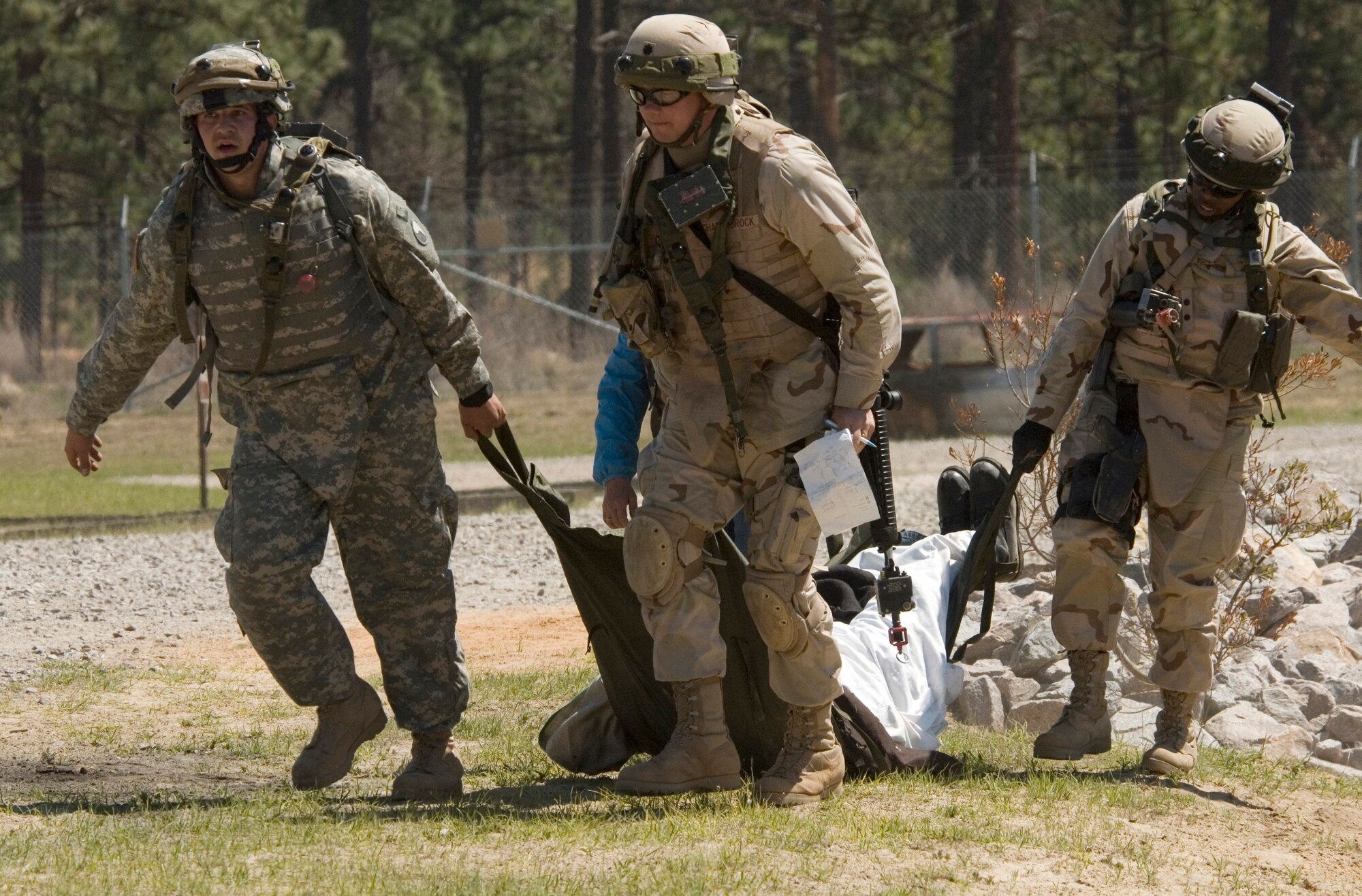 Airmen and Soldiers from a multi-service provincial reconstruction team recover simulated victims of an attack during training Tuesday, April 4, 2006, at Fort Bragg, N.C. The team's aim is to help with the reconstruction, security and governing of Afghanistan.  The team is training in the United States before deploying for a year. (U.S. Air Force photo/Master Sgt. Jack Braden)

