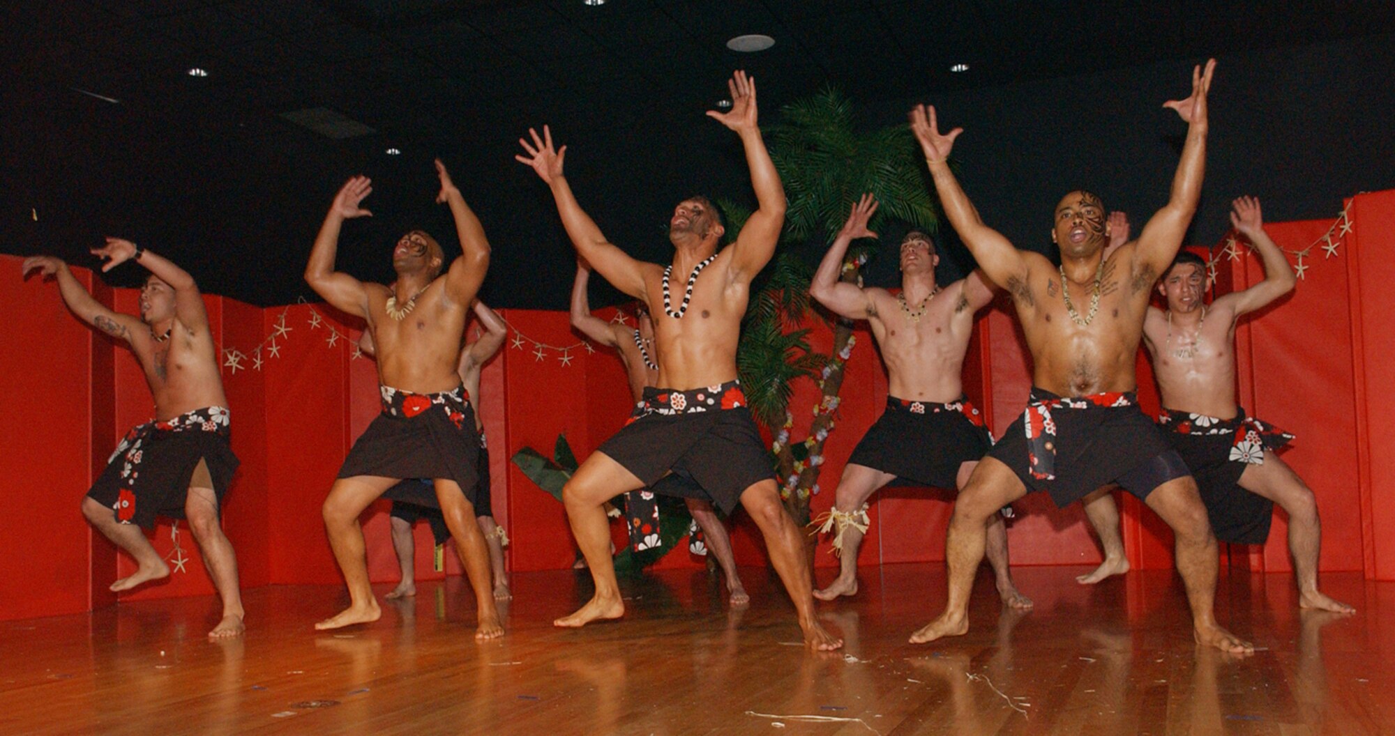 The Kane (Hawaiian for male) Dancers, perform a haka dance called Ka Mate in front of more than 250 people during the Project CHEER Luau Saturday at the Community Center. Front row left to right: Senior Airman Aristotle Munoz, Staff Sgt. Roberto George, Staff Sgt. Sydney Kneubuhl (instructor), Staff Sgt. Ivan Vargas. Back row left to right: Tech. Sgt. Norman Palone, Senior Airman Nathan Angel, Airman 1st Class Mitchell Kuykendall and Airman Robert Esquibel.