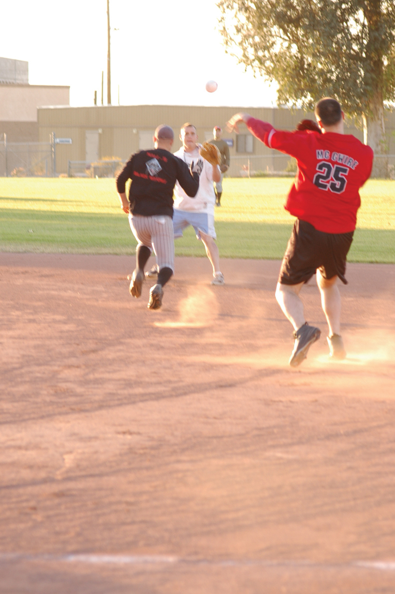 Christopher Dodson (25), Headquarters and Headquarters Squadron Search and Rescue first baseman, throws out a Marine Aviation Logistics Squadron 13 A team runner for the second out of the first inning April 5 at Field 425 here. MALS-13 A?s bats kept the SAR infield mostly unused and the outfield running for the fence for the majority of the game.