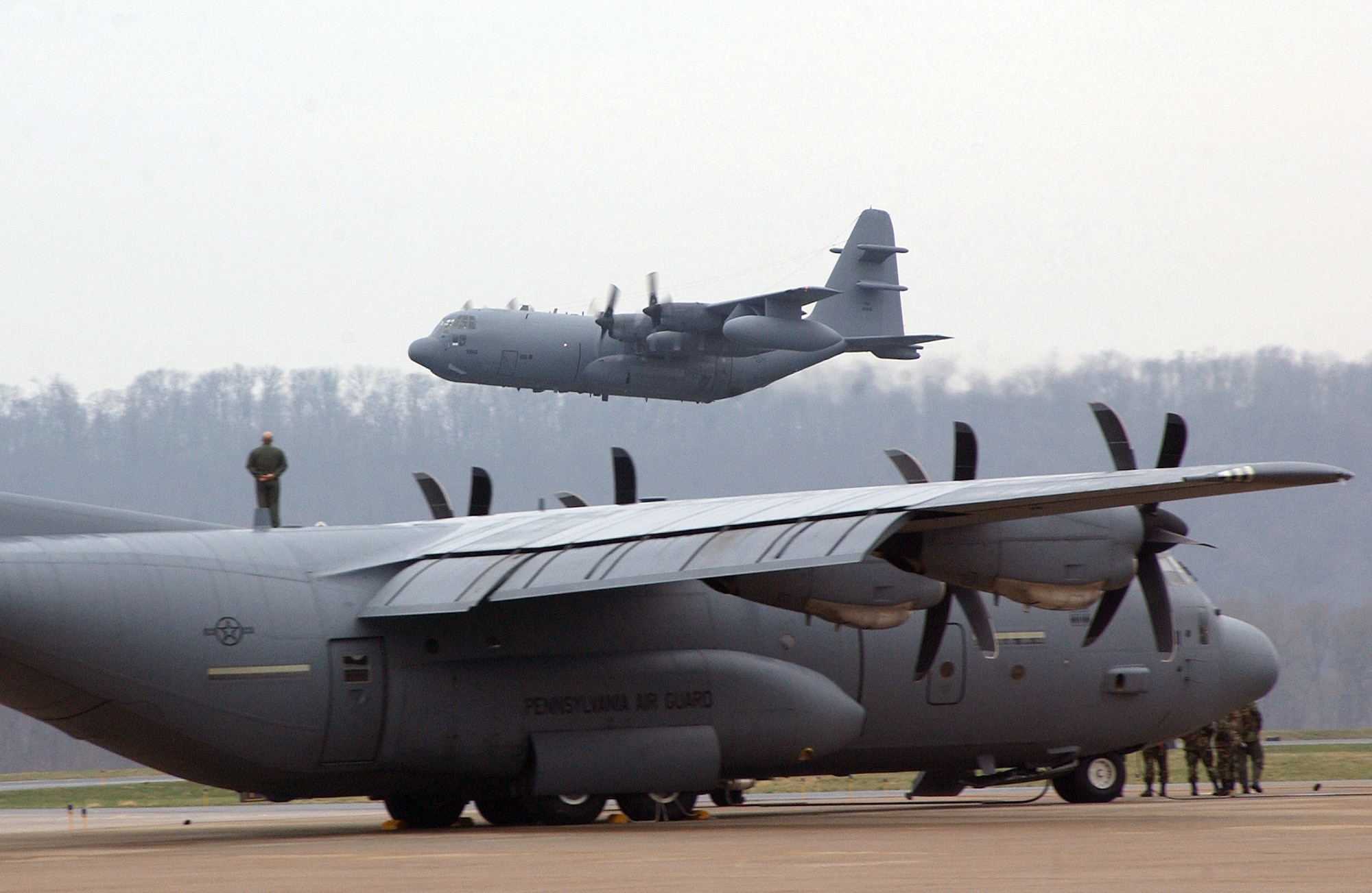 The last Air National Guard's EC-130E Commando Solo takes off above a C-130 Hercules for the final time at the Harrisburg International Airport on Monday, April 3, 2006.  The "E" model has flown members of the 193rd Special Operations Wing into combat since the Vietnam Conflict. (U.S. Air Force photo/Staff Sgt. Matt Schwartz)