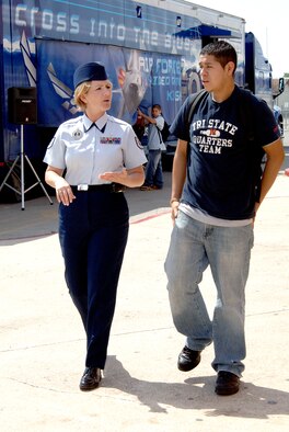 Tech. Sgt. Kathleen McCool and Stephen Rivera talk about opportunities and careers available at a recruiting event April 4, 2006, at a high school in San Antonio. Mr. Rivera was a senior in high school looking into joining the Air Force after graduation. Sergeant McCool is an Air Force recruiter. (U.S. Air Force photo/Tech. Sgt. Larry A. Simmons)