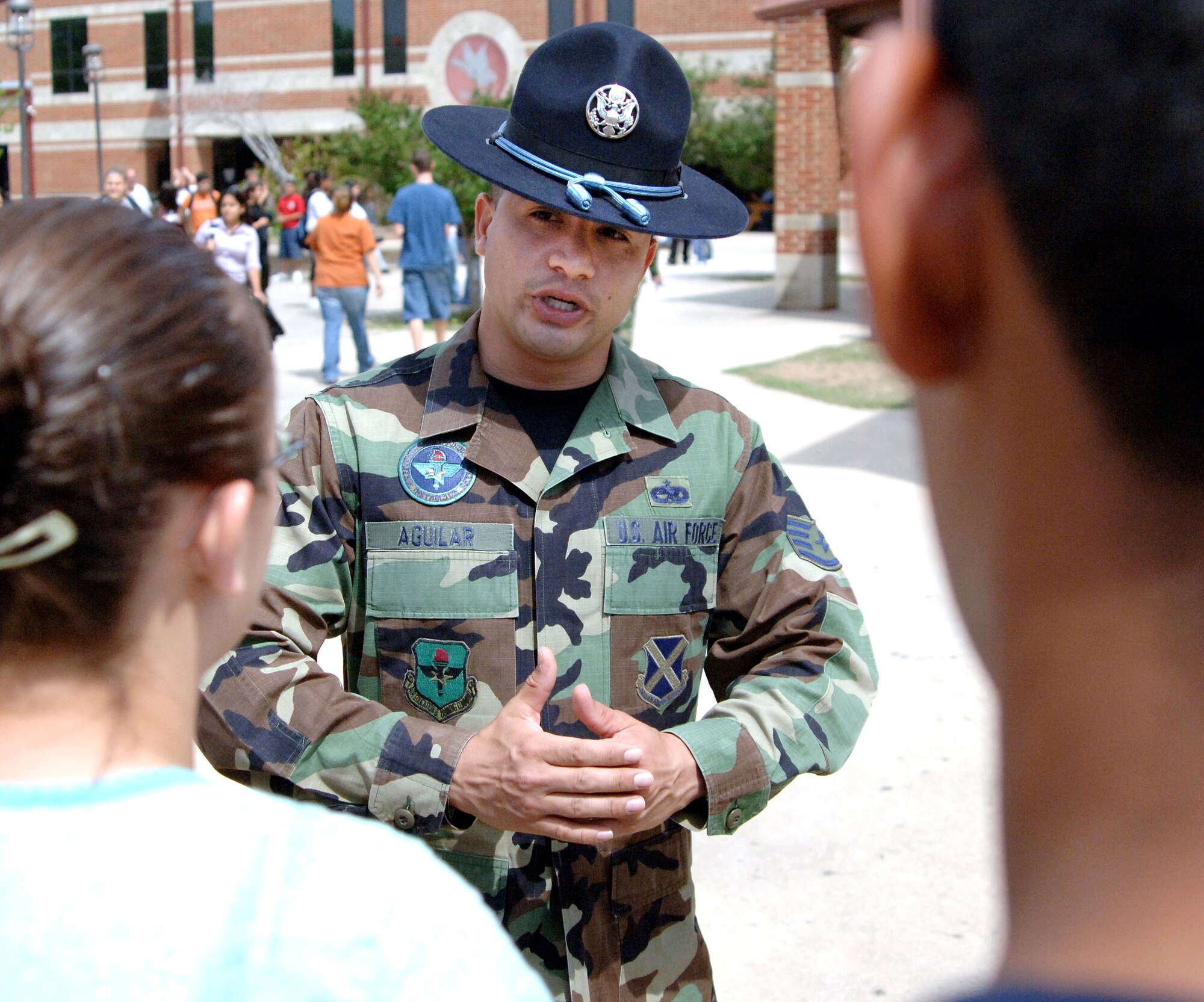 Military Training Instructor Staff Sgt. David Aguilar speaks to students and parents about experiences to be expected during basic training at a recruiting event at a San Antonio high school Tuesday, April 4, 2006. The event had video games and a semi-trailer with a short video shown inside about career opportunities and experiences in the Air Force. (U.S. Air Force photo/Tech. Sgt. Larry A. Simmons)
