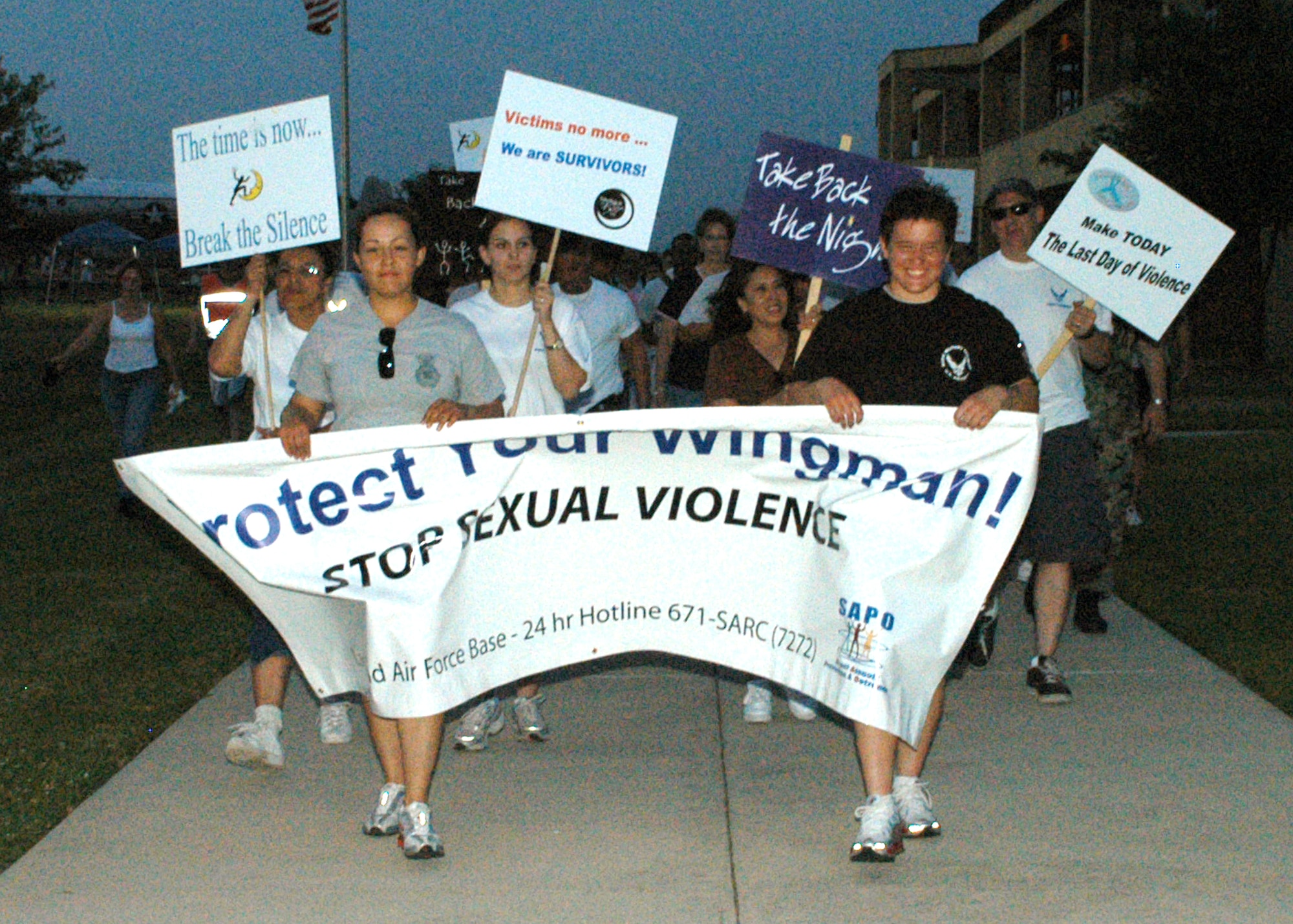 Airman 1st Class Glorya Nava (left) and Airman Ashley Hess march during "Take Back the Night" at Lackland Air Force Base, Texas, on Wednesday, April 5, 2006. They are assigned to the 37th Security Forces Squadron. (U.S. Air Force photo/Alan Boedeker)