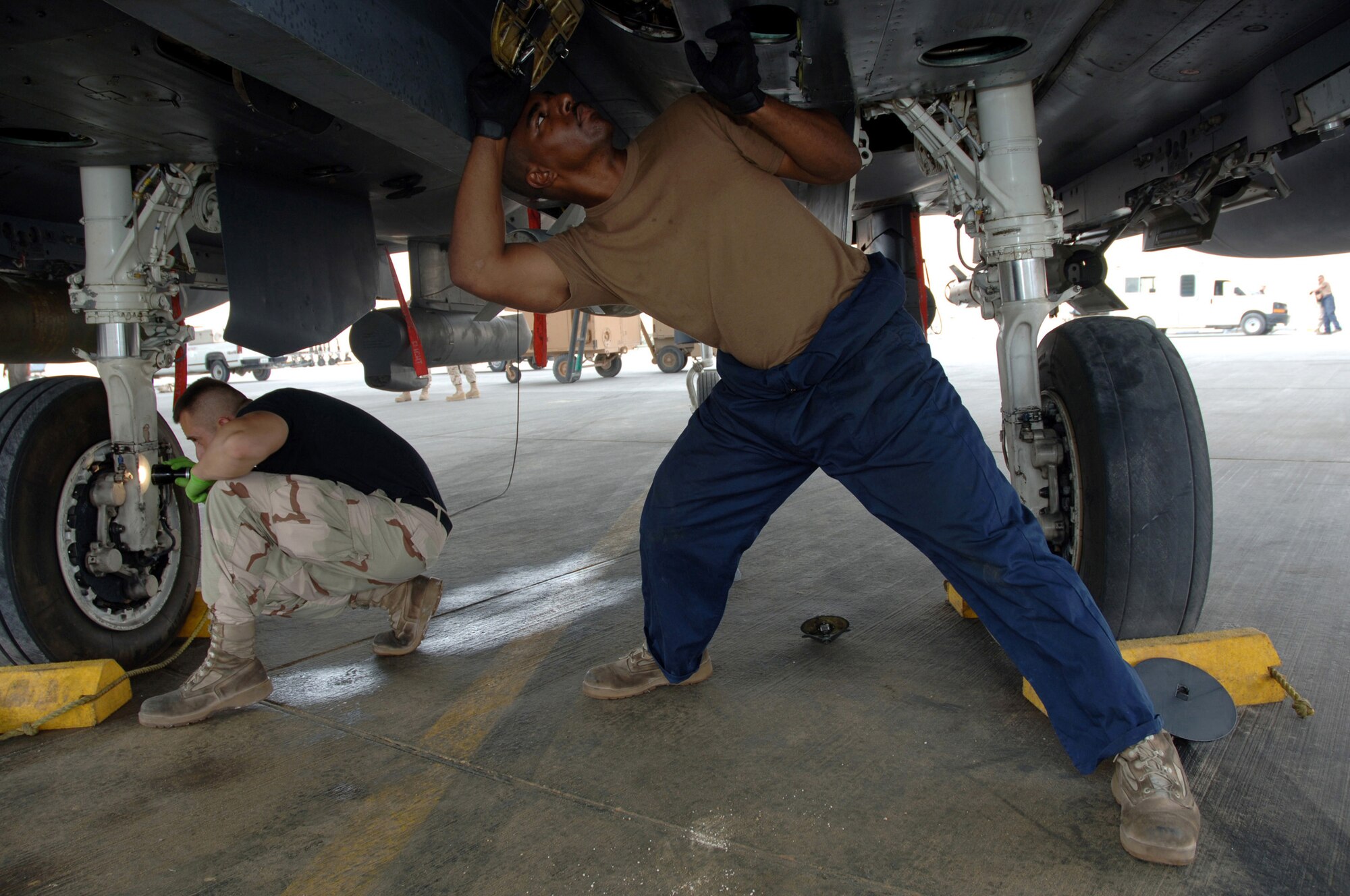 Maintainers with the 379th Expeditionary Aircraft Maintenance Squadron inspects an F-15E Strike Eagle at a forward-deployed location in Southwest Asia, on Wednesday, April 5, 2006.  The F-15E is a dual-role fighter designed to perform air-to-air and air-to-ground missions. It is deployed from Seymour Johnson Air Force Base, N.C. (U.S. Air Force photo/Staff Sgt. Joshua Strang)