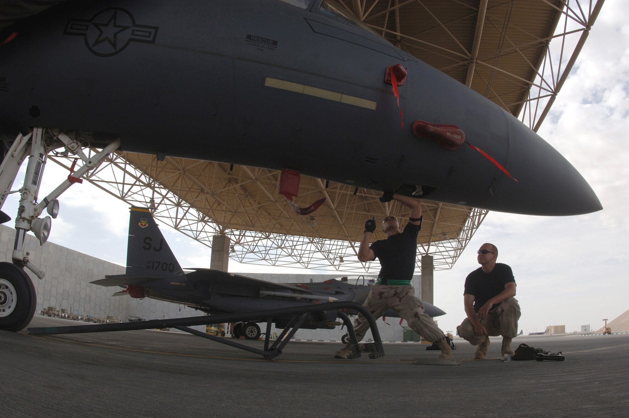 Airmen with the 379th Expeditionary Maintenance Squadron work on an F-15E Strike Eagle at a forward-deployed location in Southwest Asia, on Wednesday, April 5, 2006.  The F-15E is a dual-role fighter designed to perform air-to-air and air-to-ground missions. It is deployed from Seymour Johnson Air Force Base, N.C. (U.S. Air Force photo/Staff Sgt. Joshua Strang)