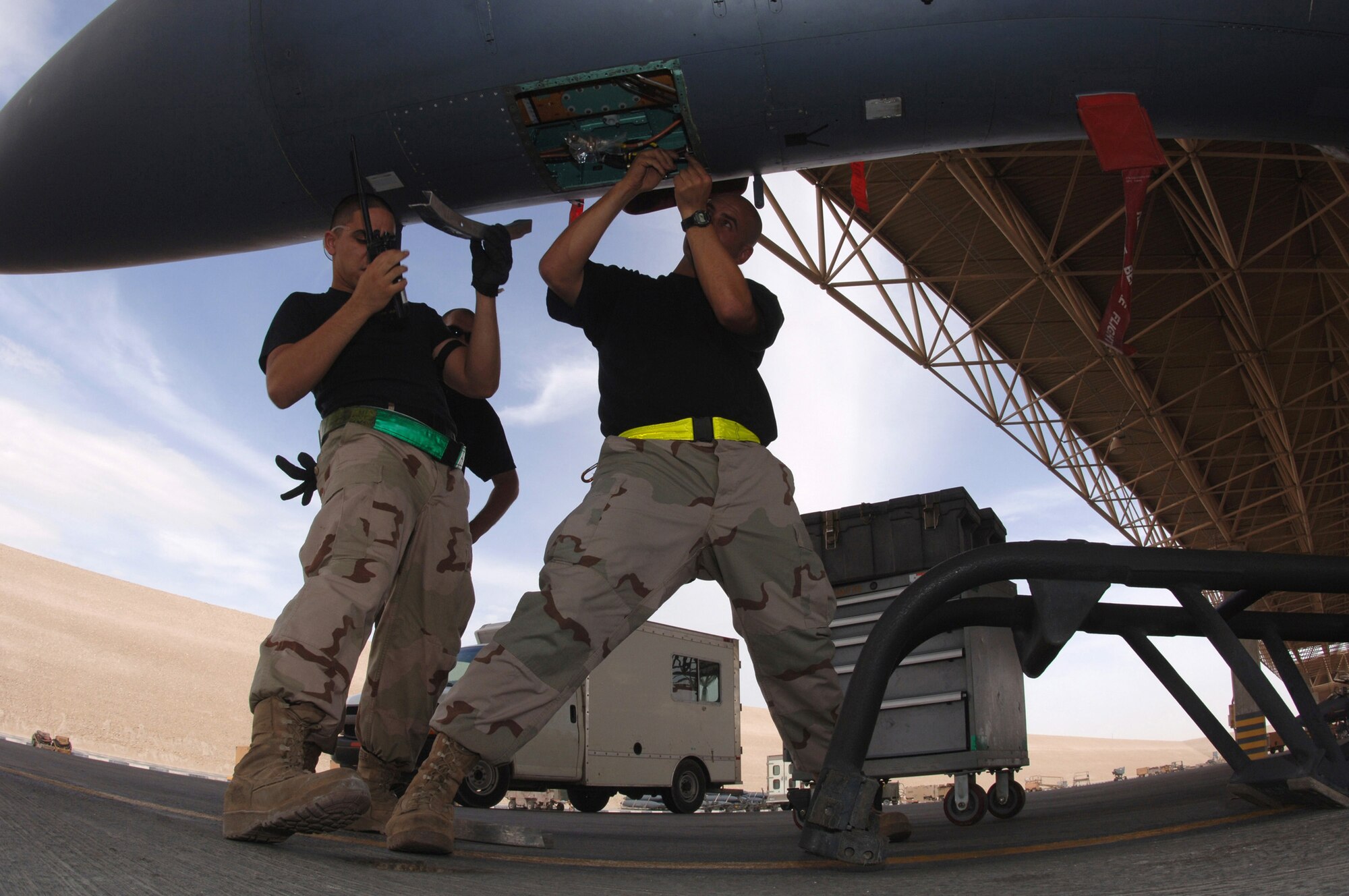 Airmen with the 379th Expeditionary Maintenance Squadron work on an F-15E Strike Eagle at a forward-deployed location in Southwest Asia, on Wednesday, April 5, 2006.  The F-15E is a dual-role fighter designed to perform air-to-air and air-to-ground missions. It is deployed from Seymour Johnson Air Force Base, N.C. (U.S. Air Force photo/Staff Sgt. Joshua Strang)