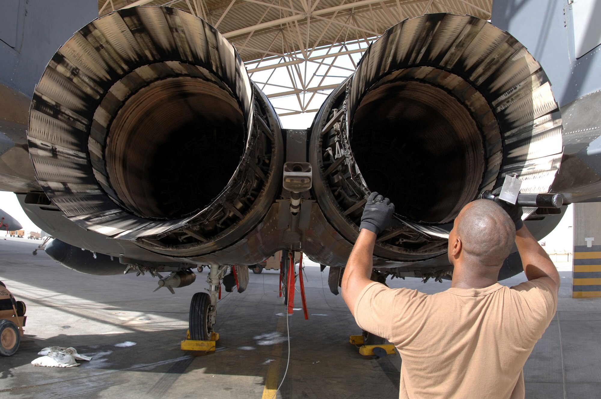 A maintainer with the 379th Expeditionary Aircraft Maintenance Squadron inspects the engine of an F-15E Strike Eagle at a forward-deployed location in Southwest Asia, on Wednesday, April 5, 2006.  The F-15E is a dual-role fighter designed to perform air-to-air and air-to-ground missions. It is deployed from Seymour Johnson Air Force Base, N.C. (U.S. Air Force photo/Staff Sgt. Joshua Strang)