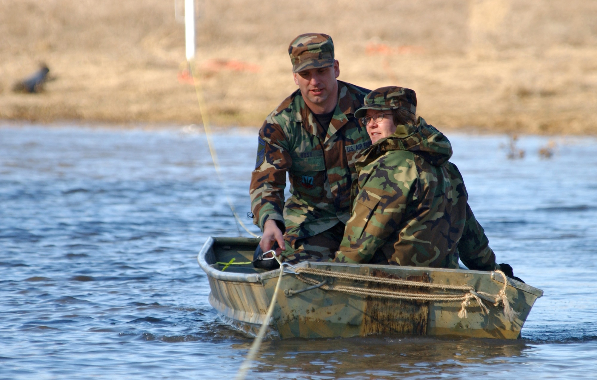 Senior Master Sgts. Brian and Kathy Rust use a boat to commute to work at the North Dakota Air National Guard in Fargo, N.D., on Monday, April 3, 2006, after the rising Wild Rice River flooded the roads near their home. Both are with the 119th Fighter Wing. (U.S. Air Force photo/Senior Master Sgt. David H. Lipp) 
