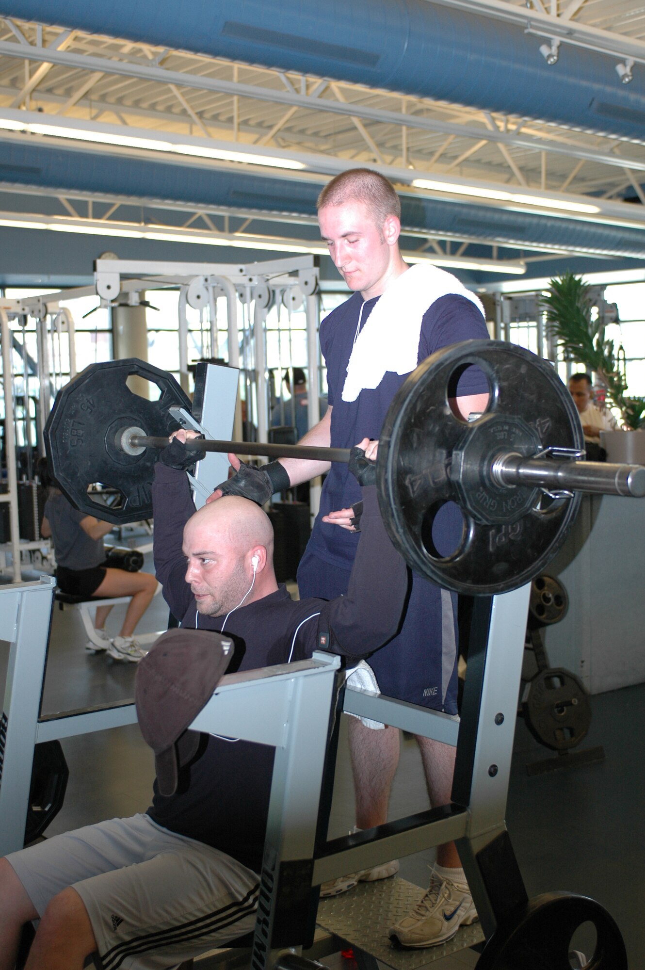 Senior Airman Bradley Parncutt, 60th Communications Squadron, provides a spot for Staff Sgt. Jeffrey Mitchell, 60th CS. Patrons are encouraged to provide a spot to others in the weightroom. (U.S. Air Force photo by Staff Sgt. Raymond Hoy)