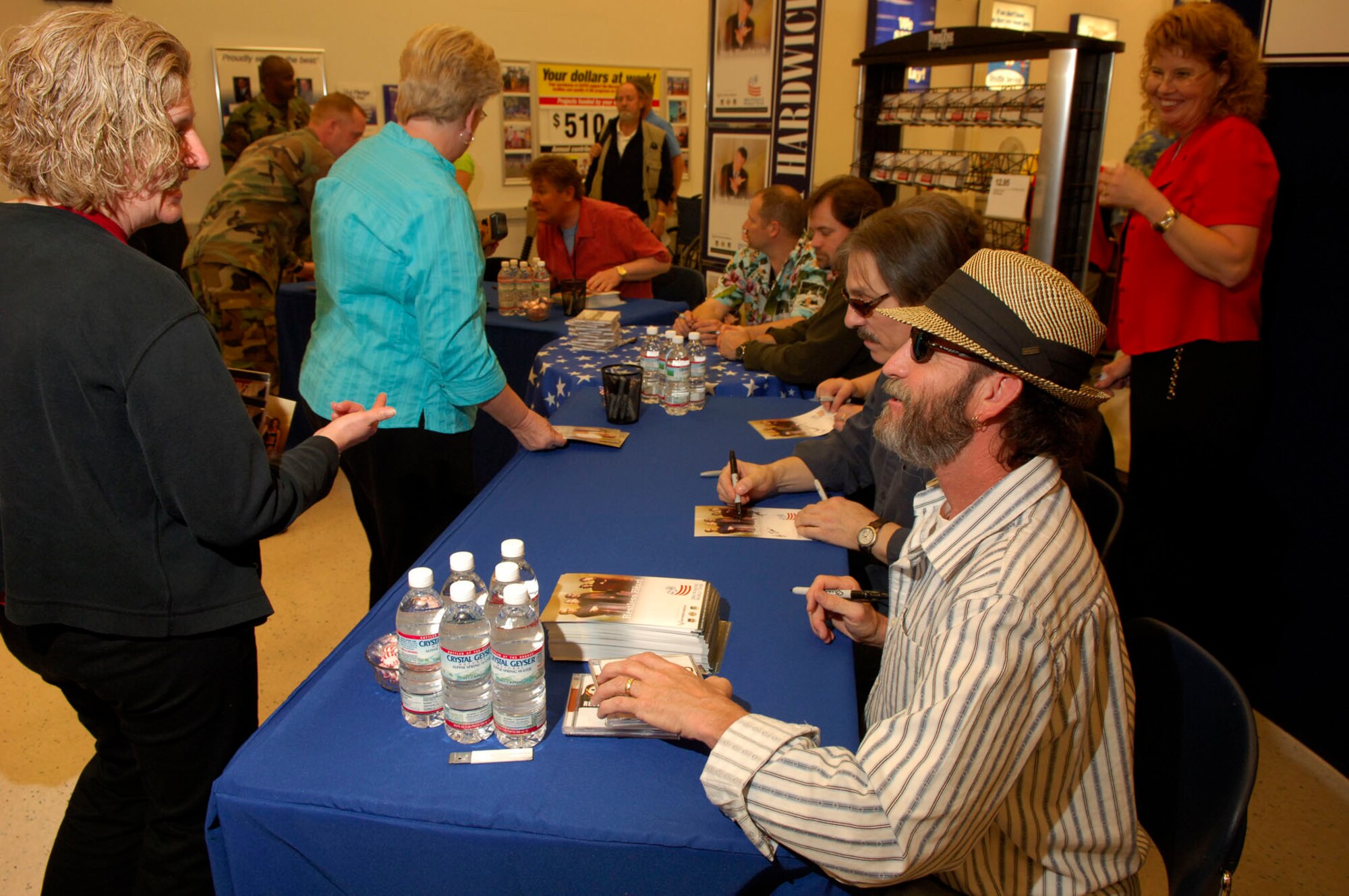 ROBINS Air Force Base, GA -- April 5, 2006 -- Members of the country music group Restless Heart sign autographs and visit with patrons at the Robins AFB Main Exchange.  The group and other guest artists depart today on a 16-day around-the-world tour to visit and perform for troops at eight locations in Europe, the Middle East and the Pacific regions.  (U.S. Air Force Photo/Ken Hackman)