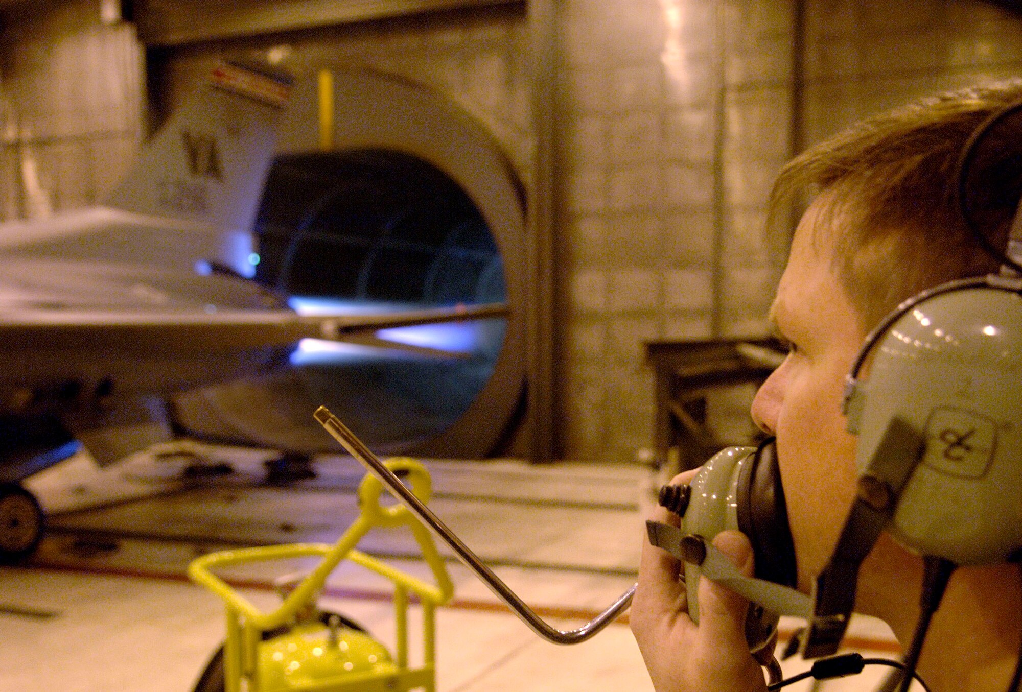 Tech. Sgt. Jonathan Cooper coordinates an engine run at the Virginia Air National Guard located at Sandstone, Va., on Friday, March 31, 2006.  The Virginia ANG is currently transitioning to the new F-22A Raptor at Langley Air Force Base and will replace the F-16 Fighting Falcons as early as October 2007.  Sergeant Cooper is a maintenance technician with the 192 Aircraft Maintenance Squadron.  (U.S. Air Force photo/Tech. Sgt. Ben Bloker)