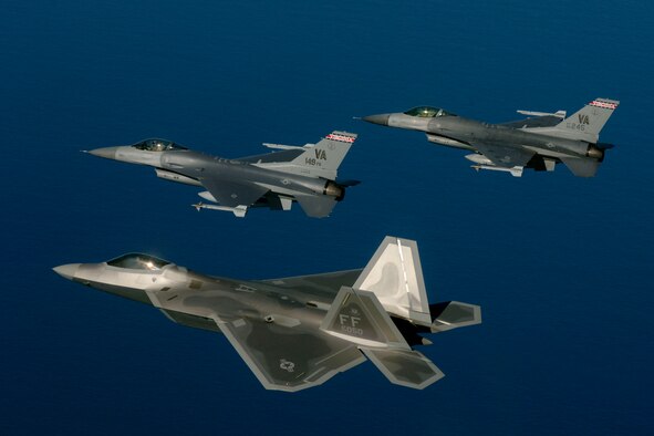 Lt. Col. Bryan Turner and Maj. Thomas McAtee fly in formation with Lt. Col. Wade Tolliver during a training mission off the coast of Virginia on Thursday, March 30, 2006. The Virginia Air National Guard is currently transitioning to the new F-22A Raptor and will replace the F-16 Fighting Falcons as early as October 2007. Colonel Turner and Major McAtee are F-16 pilots assigned to the Virginia ANG's 149th Fighter Squadron at Sandstone, Va. Colonel Tolliver is an F-22A Raptor pilot with the 27th Fighter Squadron at Langley.  (U.S. Air Force photo/Tech. Sgt. Ben Bloker)