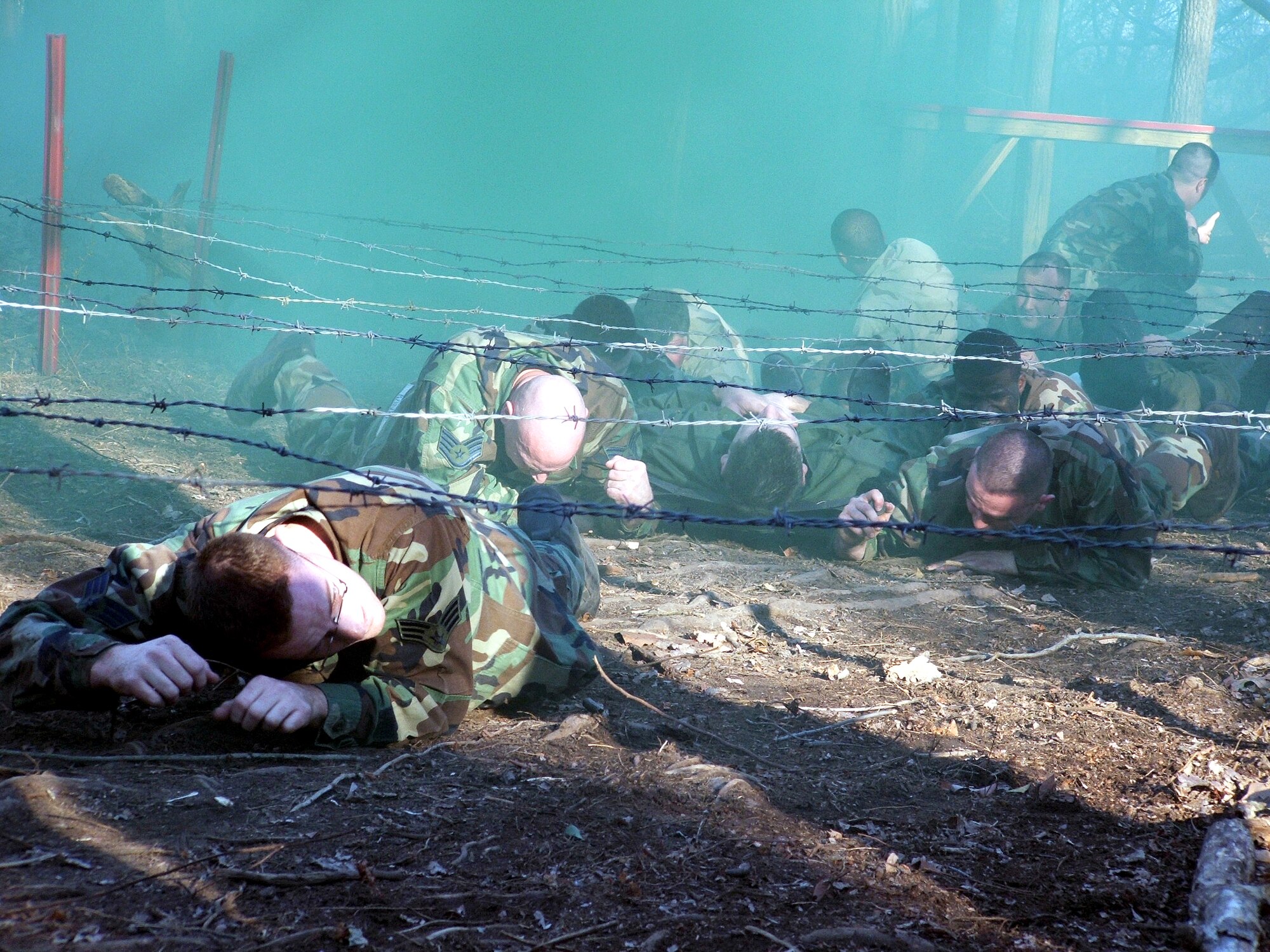 Students in the Air Force Phoenix Raven Class 06-D at Fort Dix, N.J., move a "patient" through an obstacle course during combat first aid training for the students. The students, who include Air Force security forces and Navy masters at arms personnel, receive training in everything from combat first aid and tactical self defense to aircraft security. The students undergo extensive physical training as well. The course is taught by the Air Mobility Warfare Center's 421st Combat Training Squadron. (U.S. Air Force photo/Tech. Sgt. Scott T. Sturkol)