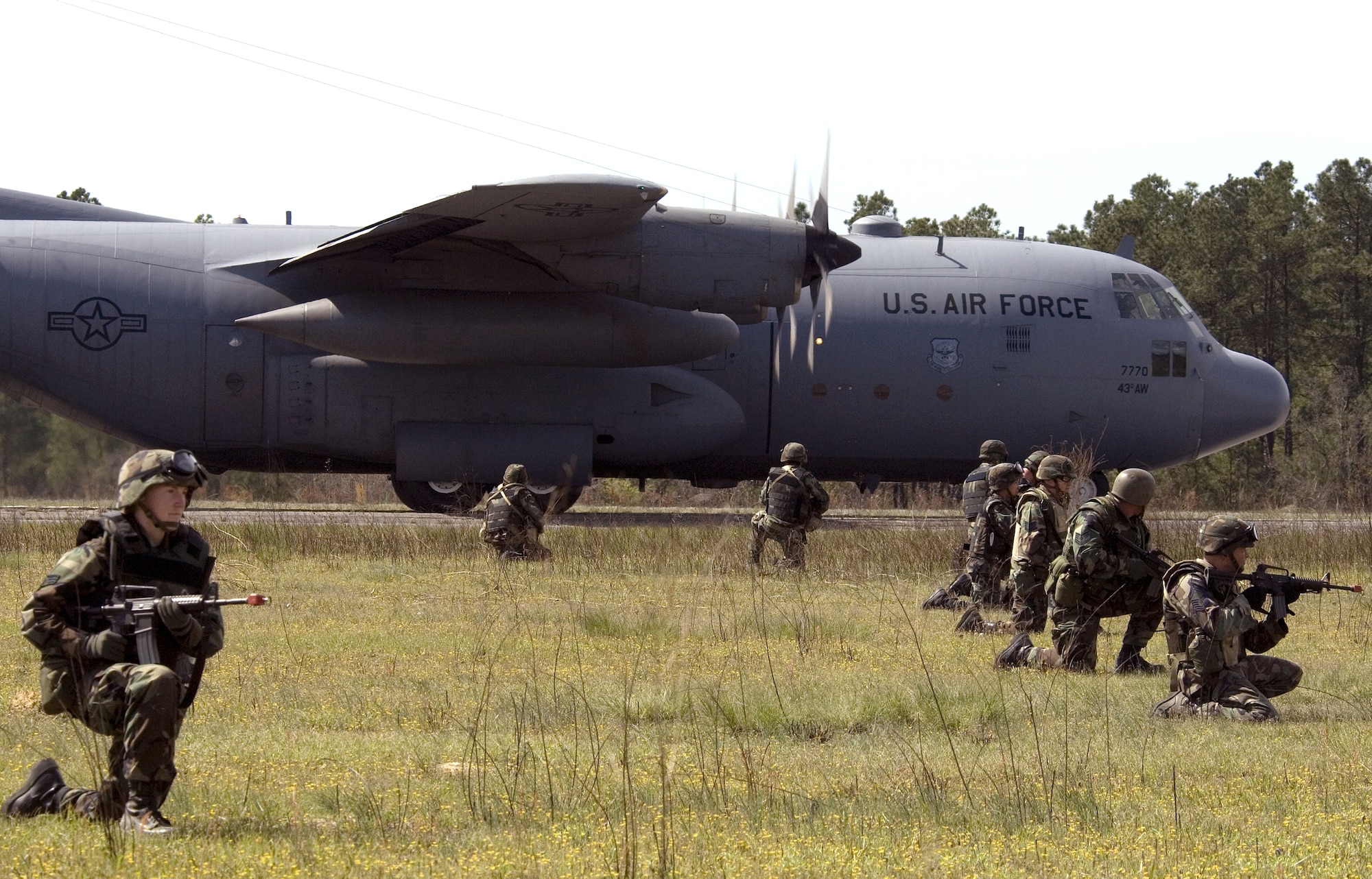 Members of the 43rd Air Evacuation Squadron at Pope Air Force Base, N.C., provide security for a C-130 Hercules evacuating patients during annual medical field training at Fort Bragg, N.C., on Thursday, April 6, 2006. The 43rd is conducting annual medical field training to prepare squadron members for real world deployments. (U.S. Air Force photo/Master Sgt Jack Braden) 