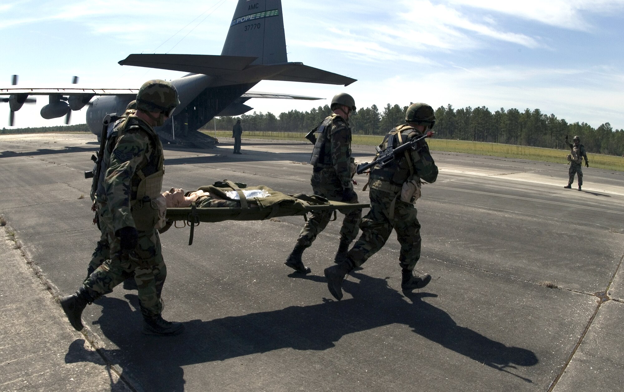 Medics with the 43rd Air Evacuation Squadron at Pope Air Force Base, N.C., transport a patient onto an awaiting C-130 Hercules on Thursday, April 6, 2006. The 43rd is conducting annual medical field training to prepare squadron members for real world deployments. (U.S. Air Force photo/Master Jack Braden)
