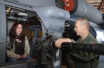 Angela Rowland, wife of Capt. Tony Rowland, 347th Aircraft Maintenance Squadron, learns about the different parts of the HH-60G Pave Hawk Saturday from Senior Airman Mike O'Neal, 41st Rescue Squadron. (Photo by Senior Airman Angelita Collins)