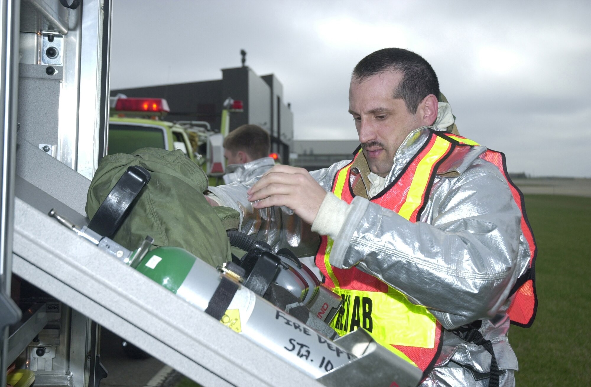 YOUNGSTOWN AIR RESERVE STATION, Ohio - Tech. Sgt. Rich Millero, a Fire Fighter assigned to the 910th Civil Engineers Squadron here, removes equipment from an emergency vehicle as part of his response to a simulated building fire. Sergeant Millero was participating in a base wide exercise during the April Unit Training Assembly. (U.S. Air Force Photo/Tech. Sgt. Ken Sloat)
