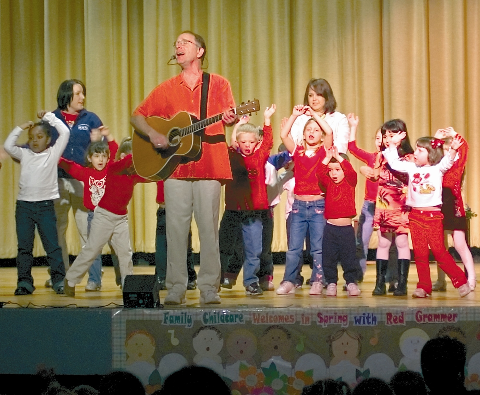 WRIGHT-PATTERSON AIR FORCE BASE, Ohio - Red Grammer sings with children from Wright Field North Child Development Center during a concert at the base theater, Kittyhawk Center, April 4. The concert, sponsored by the Family Child Care Program, was performed for base children to kick off the Month of the Military Child under the theme of "Hooray for the World." (Air Force photo by Spencer P. Lane)

