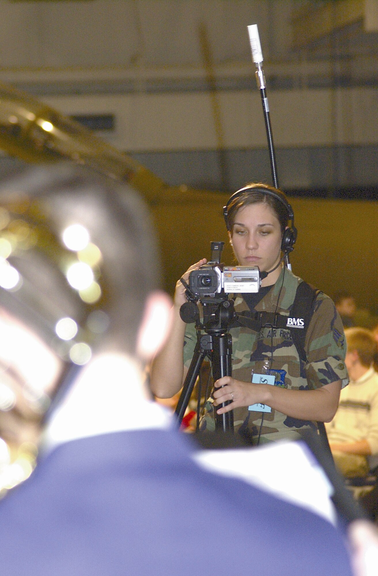 WRIGHT-PATTERSON AIR FORCE BASE, Ohio - Senior Airman Michelle Emery, Air Force Institute of Technology videographer, captures video of members of the Air Force Band of Flight during the 2006 AFIT March Graduation ceremony at the National Museum of the U. S. Air Force March 23. (Air Force photos by Senior Airman Shaun Emery)

