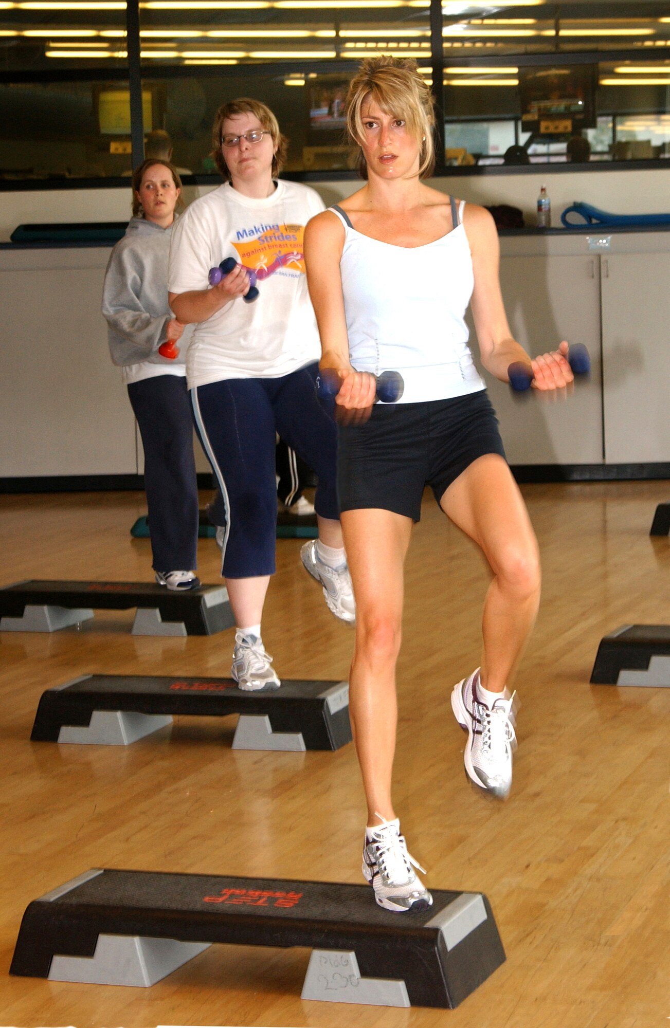 Lanette Bringham takes part in the step and stuff segment of the aerobathon. Every 20 minutes, participants of the aerobathon event were able to try a new type of aerobics class, including Pilates, Rebound and Cycling. (U.S. Air Force photo by Nan Wylie)