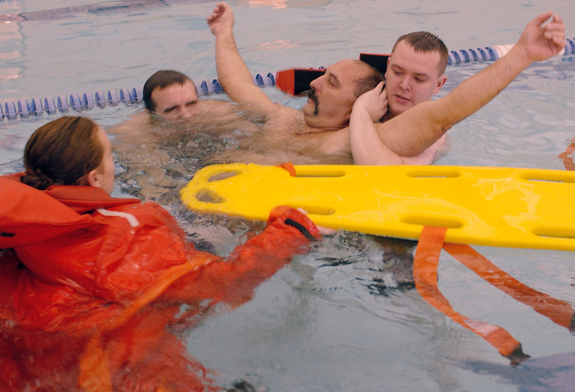Airman First Class Paul Rinehart, top left, Senior Airman(SrA) Ricky Browning, top right, and Sra Raquel Rickard, bottom left, practice water rescue on Dave Wilder in the pool at Shelbank fitness center on Langley AFB Virginia, January 18, 2006.  (U.S. Air Force photo by Airman First Class Christopher L. Ingersoll)


 
