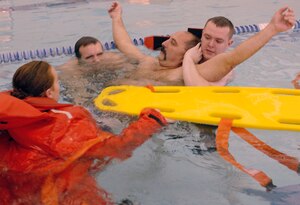 Airman First Class Paul Rinehart, top left, Senior Airman(SrA) Ricky Browning, top right, and Sra Raquel Rickard, bottom left, practice water rescue on Dave Wilder in the pool at Shelbank fitness center on Langley AFB Virginia, January 18, 2006.  (U.S. Air Force photo by Airman First Class Christopher L. Ingersoll)


 
