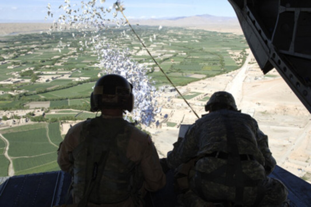 U.S. Army Sgt. 1st Class Len Tidey (left) and Sgt. 1st Class Tom Rees execute a leaflet drop over Helmand Province, Afghanistan, on April 1, 2006. 