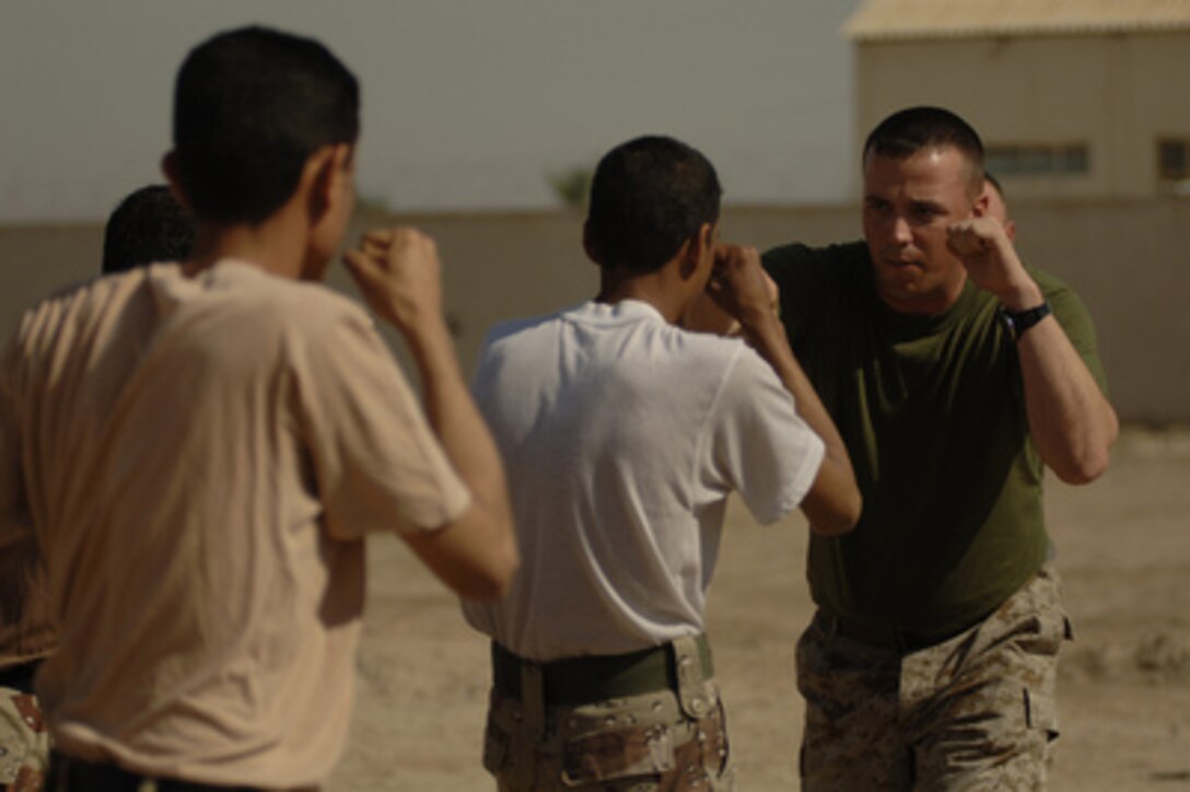 U.S. Marine Corps Staff Sgt. Joseph Kepler teaches Iraqi army soldiers how to properly throw a punch during hand-to-hand combat training in Husiniyah, Iraq, on April 4, 2006. 