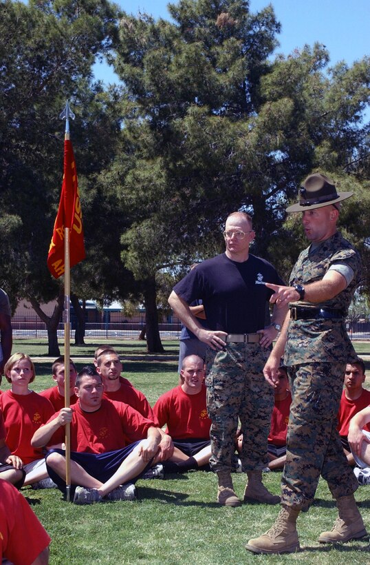 Gunnery Sgt. Dustin Kazmar, Chief Drill Instructor with Kilo Co., 3rd Recruit Training Battalion, Marine Corps Recruit Depot, San Diego, works with poolees from Recruiting Station Phoenix under the watchful eye of RS Phoenix sergeant major, Sgt. Maj. David Knutson. Knutson, while a staff sergeant on recruiting duty in Northern Minnesota, recruited Knutson, who has been promoted 6 times in his 9-year career