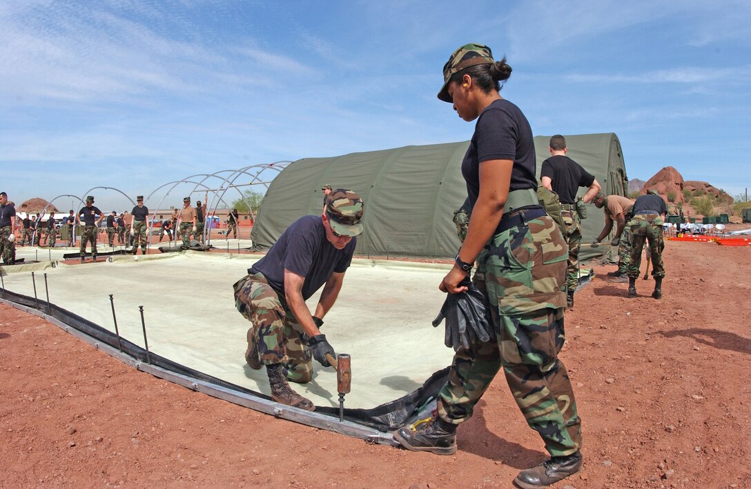 Members of the 56th Medical Group at Luke Air Force Base, Ariz., erect a mobile medical hospital during a regional training exercise April 3, 2006, at Papago Military Reservation in Phoenix. About 500 military members, including members of the 944th Fighter Wing, from across the United States are currently undergoing medical training including triage, medical command and control, medical air evacuation, patient management and transportation, and wound care as part of the "Coyote Crisis Campaign." This training allows military members to work closely with community medical assets to prepare for events like natural disasters or terrorist attacks. (U.S. Air Force photo/Master Sgt. Garrett McClure)              