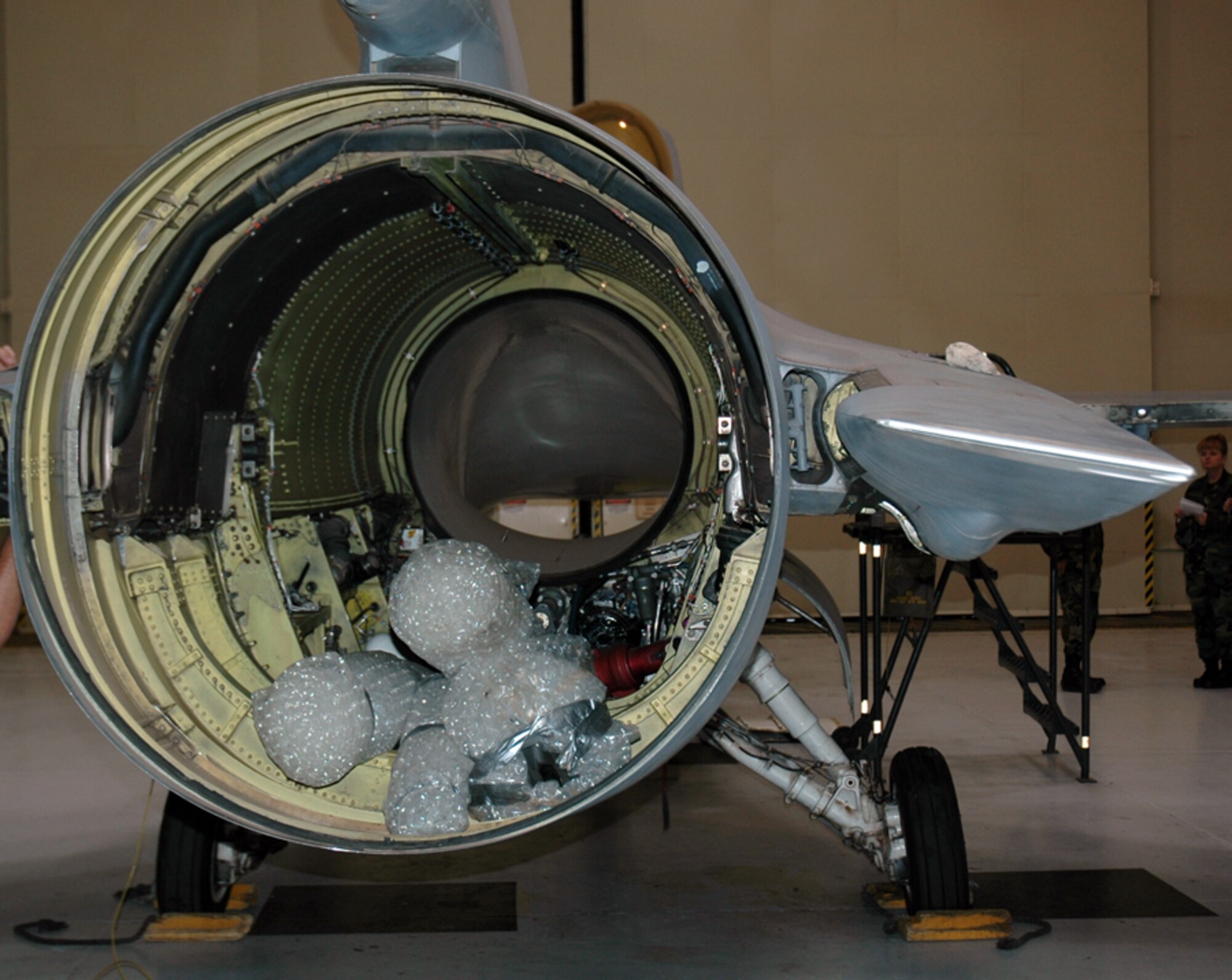 An F-16 being prepared for permanent static display in front of the 944th Fighter Wing Headquarters building sits powerless as it undergoes parts stripping and restoration. The F-16 arrived from Sheppard Air Force Base, Texas, on April 4, 2006, and will be unveiled during the Tuskegee annual convention in August. (U.S. Air Force photo/Staff Sgt. Stephen Razo)