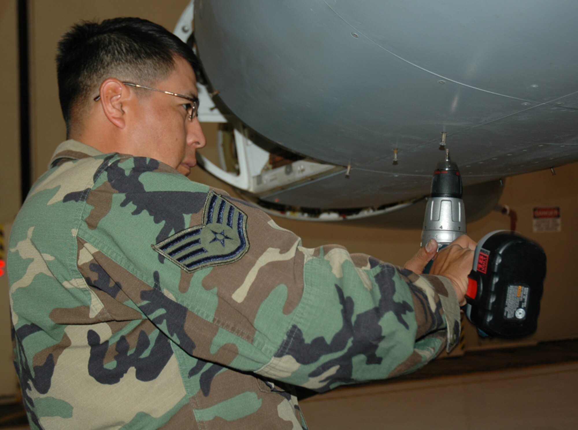 Staff Sgt. Daniel Thompson, 944th Maintenance Squadron aircraft fuels system mechanic, removes rivets from an access panel as part of the F-16 static display preparation process. (U.S. Air Force photo/Staff Sgt. Stephen Razo)
