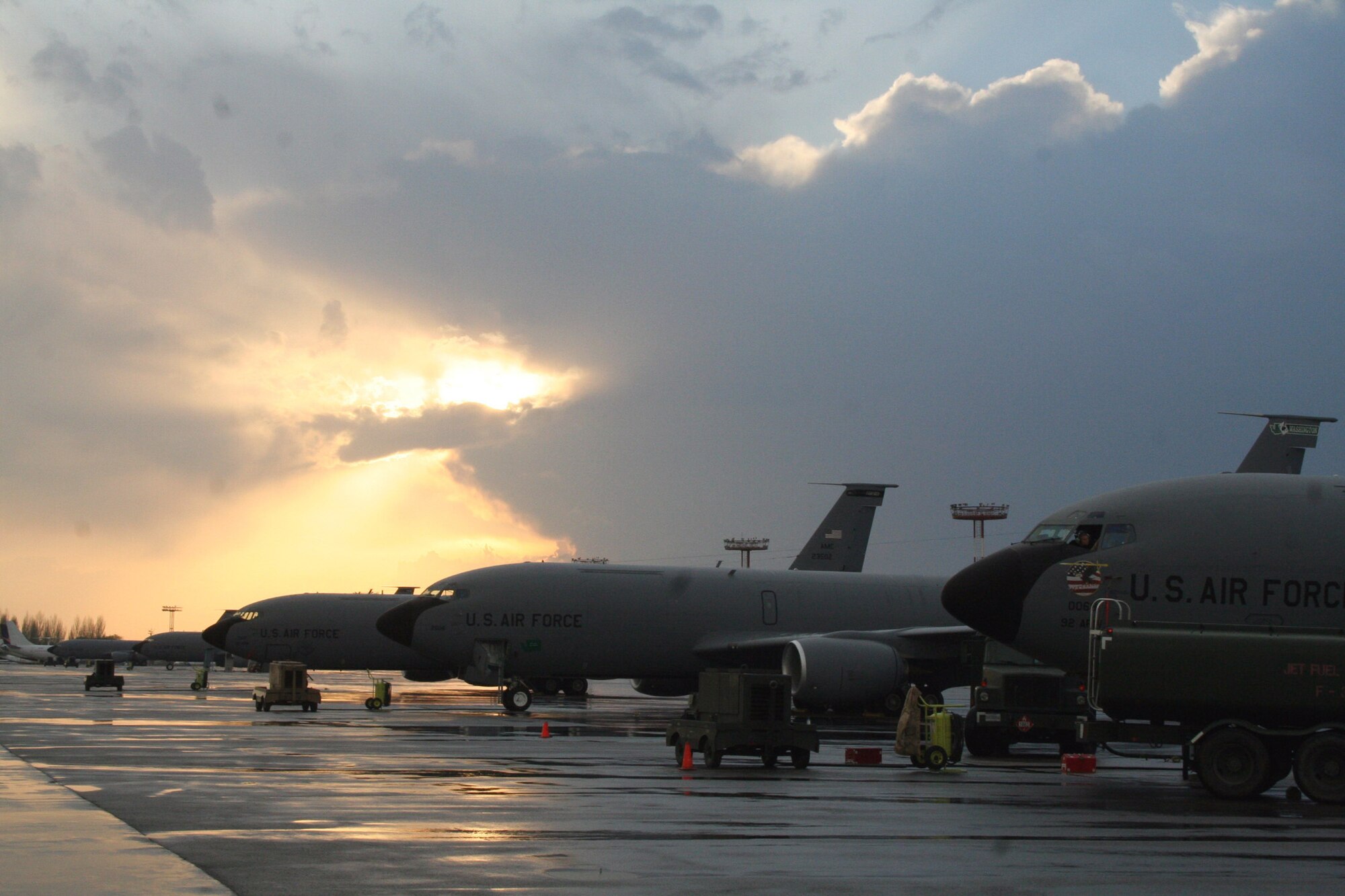 An unseasonal thunderstorm clears just as the sun sets over the flightline at Manas Air Base, Kyrgyzstan, where  KC-135 Stratotanker aircrews waited out the worst of the lightning before taking off.  (U.S. Air Force photo/Staff Sgt. Lara Gale)
