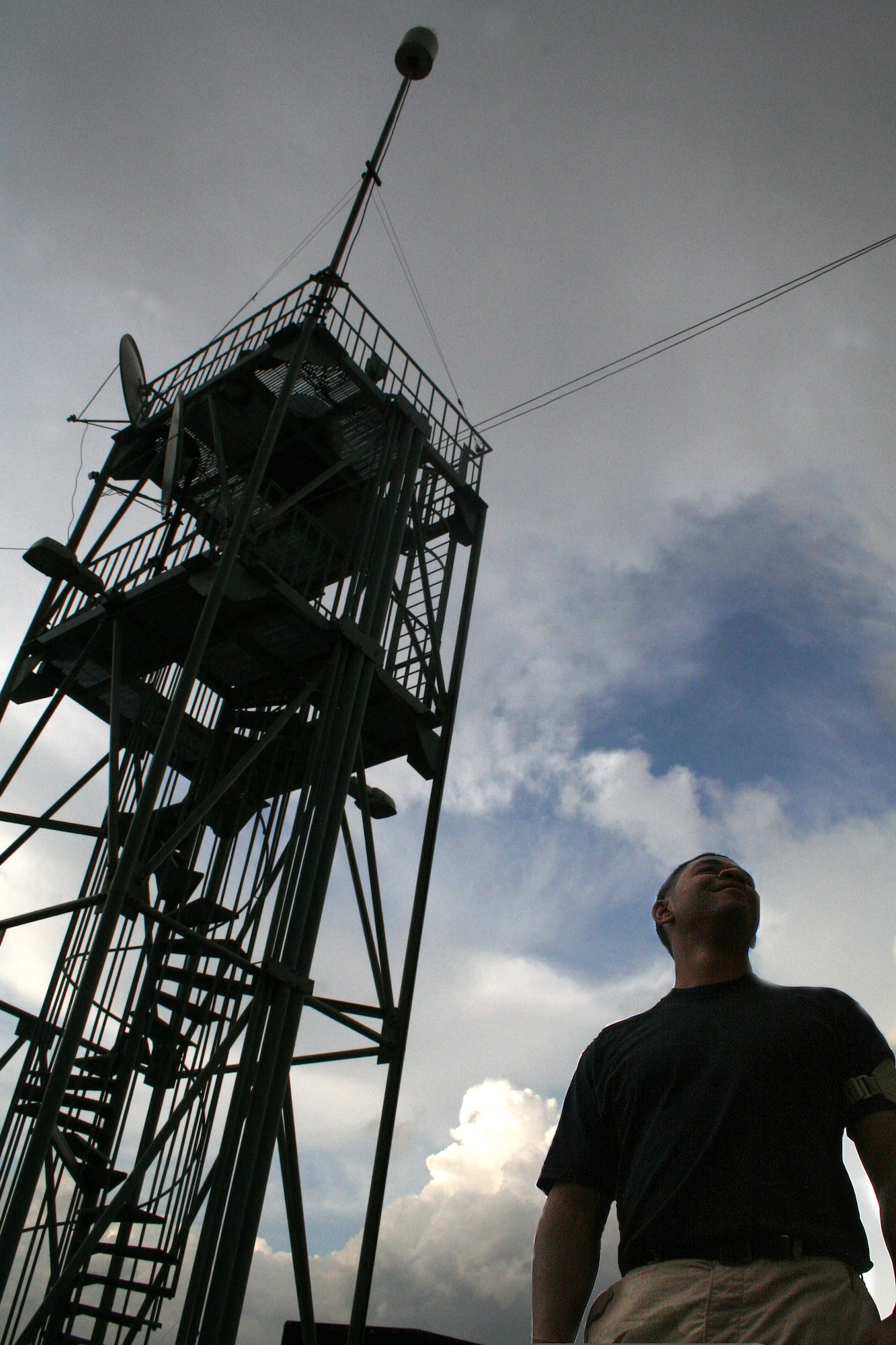 Staff Sgt. Robert Cook watches a storm move south at Manas Air Base, Kyrgyzstan. The weather flight transmits updates every 15 minutes during weather events such as a thunderstorm, based on satellite images and their physical observation of the skies overhead.  (U.S. Air Force photo/Staff Sgt. Lara Gale)
